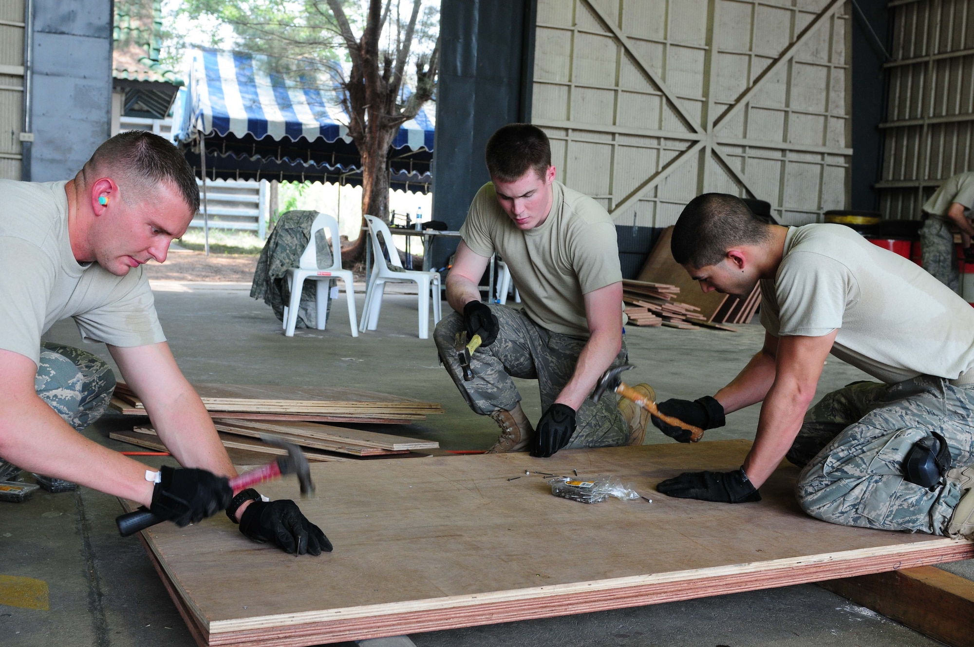 (Left to right) Staff Sgt. Jeremy Hayes, Airman First Class Matthew Brewer and Airman First Class Tyler Siebrass prepare pallets Feb. 28 that will be used for airdrops conducted during this year’s exercise Cope Tiger at Udon Thani Royal Thai Air Force Base, Thailand, March 1-12. Cope Tiger is an annual multilateral exercise involving the United States, Thailand and Singapore. Sergeant Hayes is deployed from Joint Base Pearl Harbor Hickam, Hawaii; Airman Brewer is from Yokota Air Base, Japan; and Airman Siebrass is from Elmendorf Air Force Base, Alaska. (U.S. Air Force photo/by Capt. Genieve David)