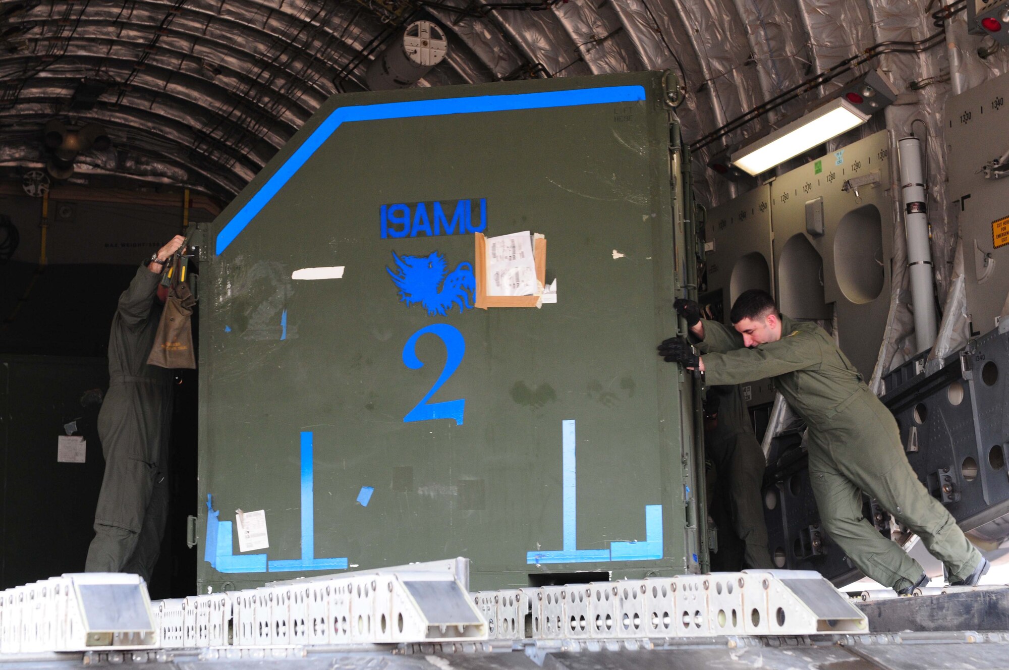 Senior Airman David Russell (right) removes cargo from a C-17 Globemaster III at Udon Thani Royal Thai Air Force Base, Thailand, on Feb. 28 in preparation for exercise Cope Tiger 2010, which will take place March 1-12.  Cope Tiger is an annual multilateral exercise involving the United States, Thailand and Singapore.  Airman Russell is deployed to Udon Thani from the 3rd Wing at Elmendorf Air Force Base, Alaska. (U.S. Air Force photo/Capt. Genieve David)