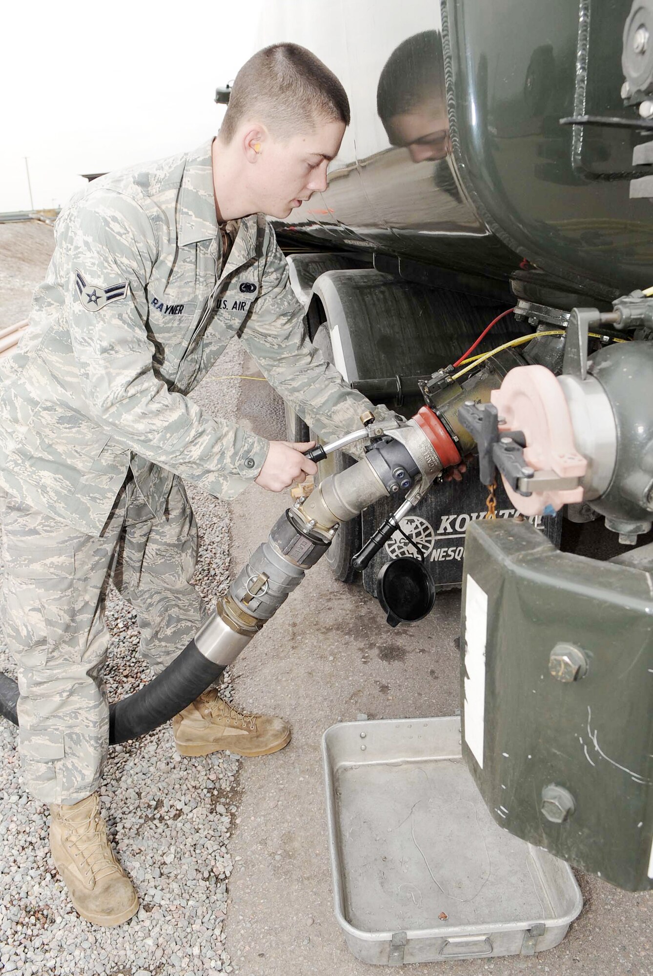 Airman 1st Class Jason Rayner pumps fuel into a petroleum, oil and lubricants fuel truck Feb. 26, 2010, at the Transit Center at Manas, Kyrgyzstan.  Airman Rayner is a fuels journeyman assigned to the 376th Expeditionary Logistics Readiness Squadron. (U.S. Air Force photo/Senior Airman Nichelle Anderson)