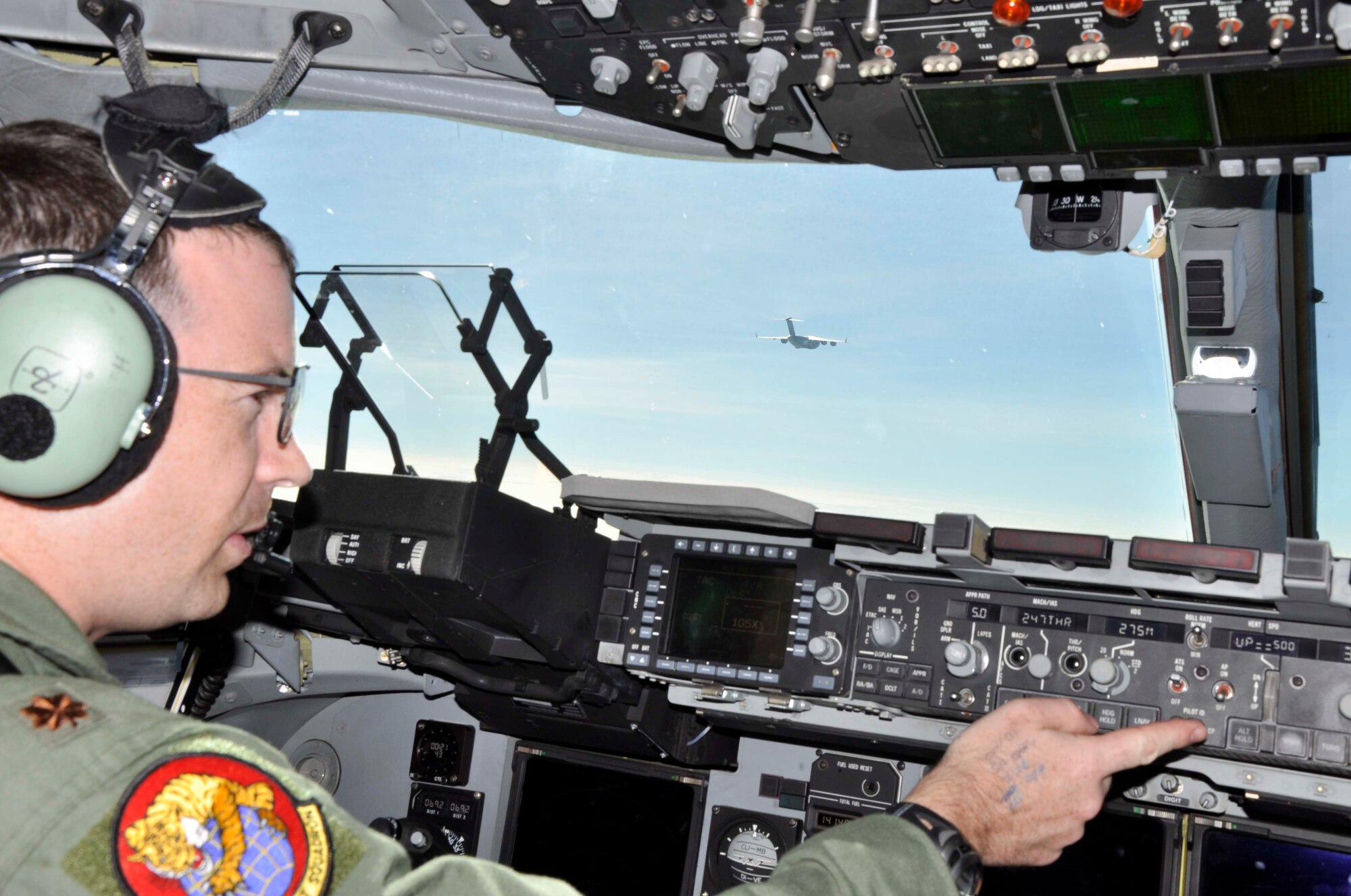 Maj. Sean Papworth maneuvers a C-17 Globemaster III into position off the right wing of another C-17 shortly after take-off from Joint Base Pearl Harbor Hickam, Hawaii, on Feb. 25.  Both aircraft flew in a two-ship formation from Hawaii to Thailand.  There they will participate in Cope Tiger 2010, an annual, multilateral field training exercise involving the U.S. Air Force, Royal Thai Air Force and Army, and the Republic of Singapore Air Force March 1-12.  Major Papworth is from the 535th Airlift Squadron at JB Pearl Harbor Hickam.  (U.S. Air Force photo/Capt. Christy Stravolo)