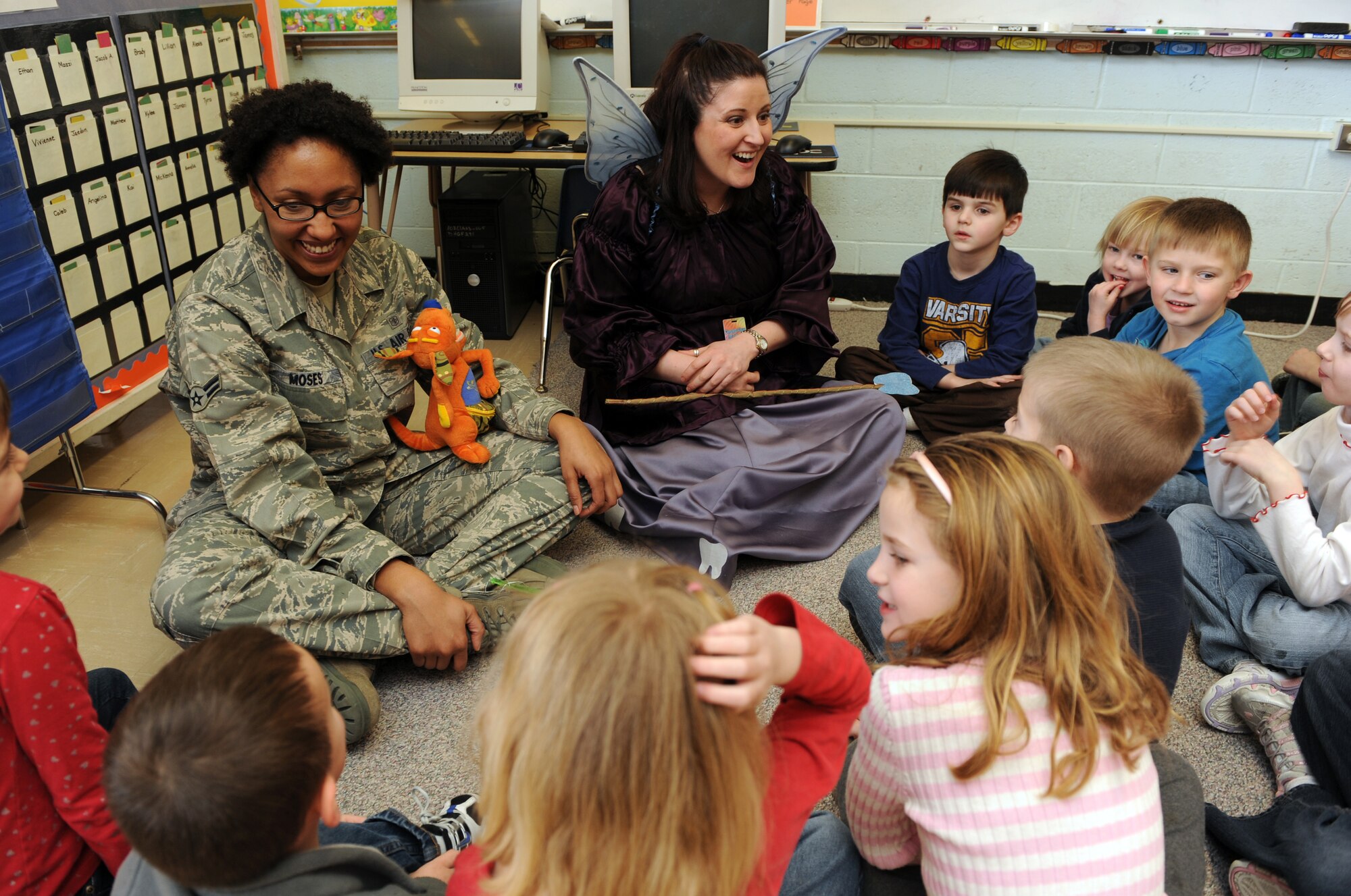 MOUNTAIN HOME AIR FORCE BASE, Idaho -- Airman 1st Class Harlandria Moses, 366th Dental Squadron dental assistant, and the Tooth Fairy speak to Mrs. Pelkey's kindergarten class, during a visit to the base primary school Feb. 25. The dental squadron visited the school to teach children from kindergarten to fourth grade the importance of dental health for Children's Dental Health month celebrated every February. (U.S. Air Force photo by Airman 1st Class Debbie Lockhart)