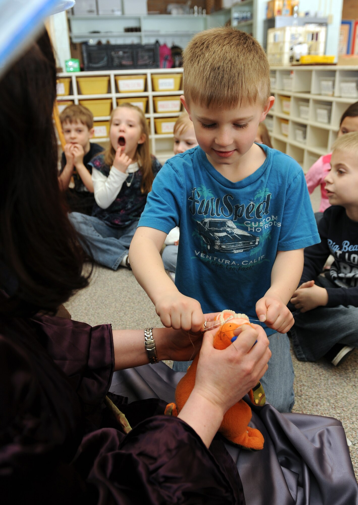 MOUNTAIN HOME AIR FORCE BASE, Idaho -- The Tooth Fairy teaches James, a student in Mrs. Pelkey's kindergarten class, how to floss during a visit to the base primary school Feb. 25. The dental squadron visited the school to teach children from kindergarten to fourth grade the importance of dental health for Children's Dental Health month celebrated every February. (U.S. Air Force photo by Airman 1st Class Debbie Lockhart)