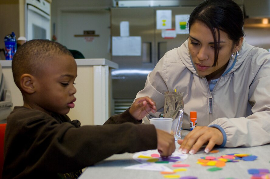 1st Lt. Yvette Cruz, 56th Force Support Squadron chief of military personnel services flight, creates a rainbow fish with Maurice, a child at the Childrens Crisis Nursery center,  Feb 27, 2010. The volunteers not only did arts and crafts, but played games and read stories to the children as well. (U.S. Air Force Photo by Staff Sgt. Jason Colbert)