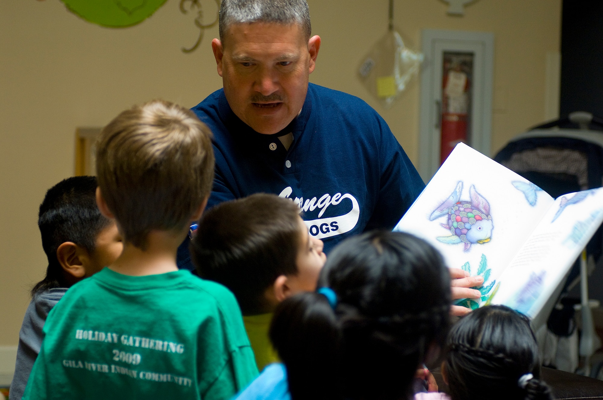 Master Sgt. James Moore, 56th Communications Squadron First Sgt., reads a book to the children of the Childrens Crisis Nursery Outreach, Feb 27, 2010. Luke members volunteer to visit the children once a month. (U.S. Air Force Photo by Staff Sgt. Jason Colbert)

