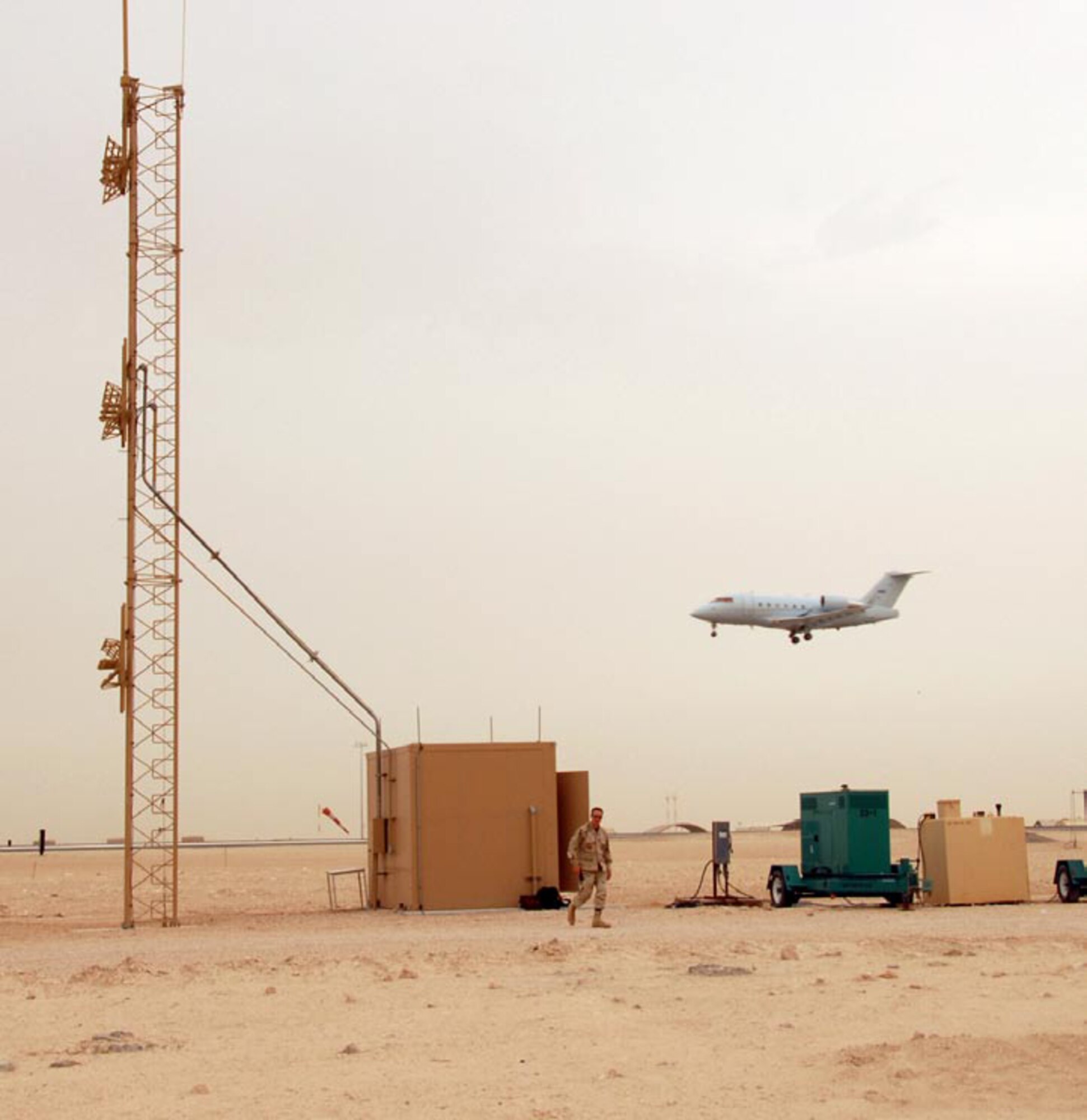 A modified CL-60 Challenger aircraft flies a low level approach past an Instrument Landing System being used in theater in 2007.  The 853rd Electronic Systems Group will soon be releasing a request for proposals for a Deployable Instrument Landing System, which will be leaner and more transportable.  (AF photo/Airman 1st Class Gustavo Gonzalez)