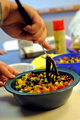 ELLSWORTH AIR FORCE BASE, S.D. -- Senior Airman Sarah Greear, 28th Medical Operations Squadron diet therapy technician, mixes ingredients together during a heart-healthy recipe demonstration, Feb. 26. The Health and Wellness Center hosted the demonstration to inform the base populace about various recipes to facilitate a healthy lifestyle. (U.S. Air Force photo/Airman 1st Class Matthew Flynn)