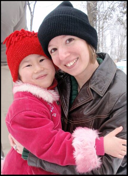 Staff Sgt. Nicole Curran with one of the children from the Nizhanchuisk Orphanage. Sergeant Curran is the new liaison between the Humanitarian Assistance office at the Transit Center at Manas and the principal at the orphanage. (U.S. Air Force photo)