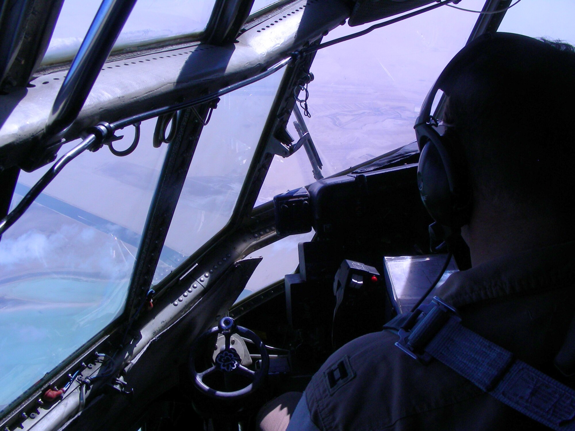 Deployed Airmen from the 911th Airlift Wing, Pittsburgh Air Reserve Station, Pa. perform inter-theater airlift using their C-130H Hercules in support of Operations Enduring and Iraqi Freedom. Shown here a Pittsburgh crew flies over the Persian Gulf from their deloyed unit, 379th Air Expeditionary Wing, at undisclosed base in Southwest Asia, to support the ground battle in Marjah, Afghanistan and elsewhere by delivering vital assets, ground equipment and personnel - anything and everything needed to support the ground war. This C-130H was hand painted with a Pittsburgh Pirates' mural upon its nose to show its Pittsburgh Spirit as it flies combat missions throughout Southwest Asia waving a yellow tail-banner with the words Pittsburgh scrawled in black.  Team Pittsburgh consists of multiple aircrew, aircraft, as well as numerous maintenance and support personnel. (U.S. Air Force Photo/Capt. Cathleen Snow)