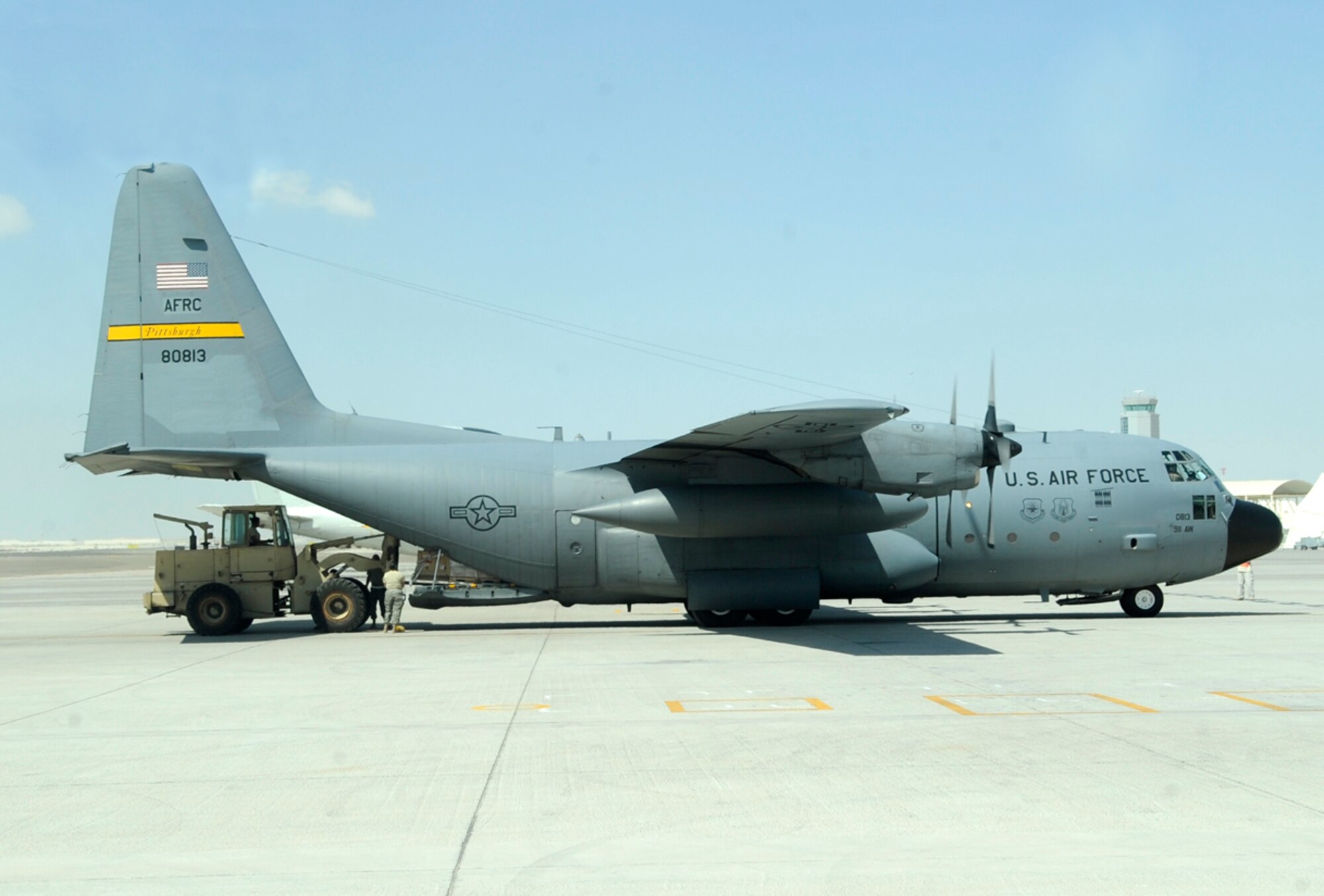 Deployed Airmen from the 911th Airlift Wing, Pittsburgh Air Reserve Station, Pa. perform inter-theater airlift using their C-130H Hercules in support of Operations Enduring and Iraqi Freedom. While their friends and family back home battle record snowfall, the crew attached to the 379th Air Expeditionary Wing at undisclosed base in Southwest Asia, supports the ground battle in Marjah, Afghanistan, and elsewhere by delivering vital assets, ground equipment and personnel - anything and everything needed to support the ground war. This C-130H was hand painted with a Pittsburgh Pirates' mural upon its nose to show its Pittsburgh Spirit as it flies combat missions throughout Southwest Asia waving a yellow tail-banner with the words Pittsburgh scrawled in black. Team Pittsburgh consists of multiple aircrew, aircraft, as well as numerous maintenance and support personnel. (U.S. Air Force Photo/Capt. Cathleen Snow)