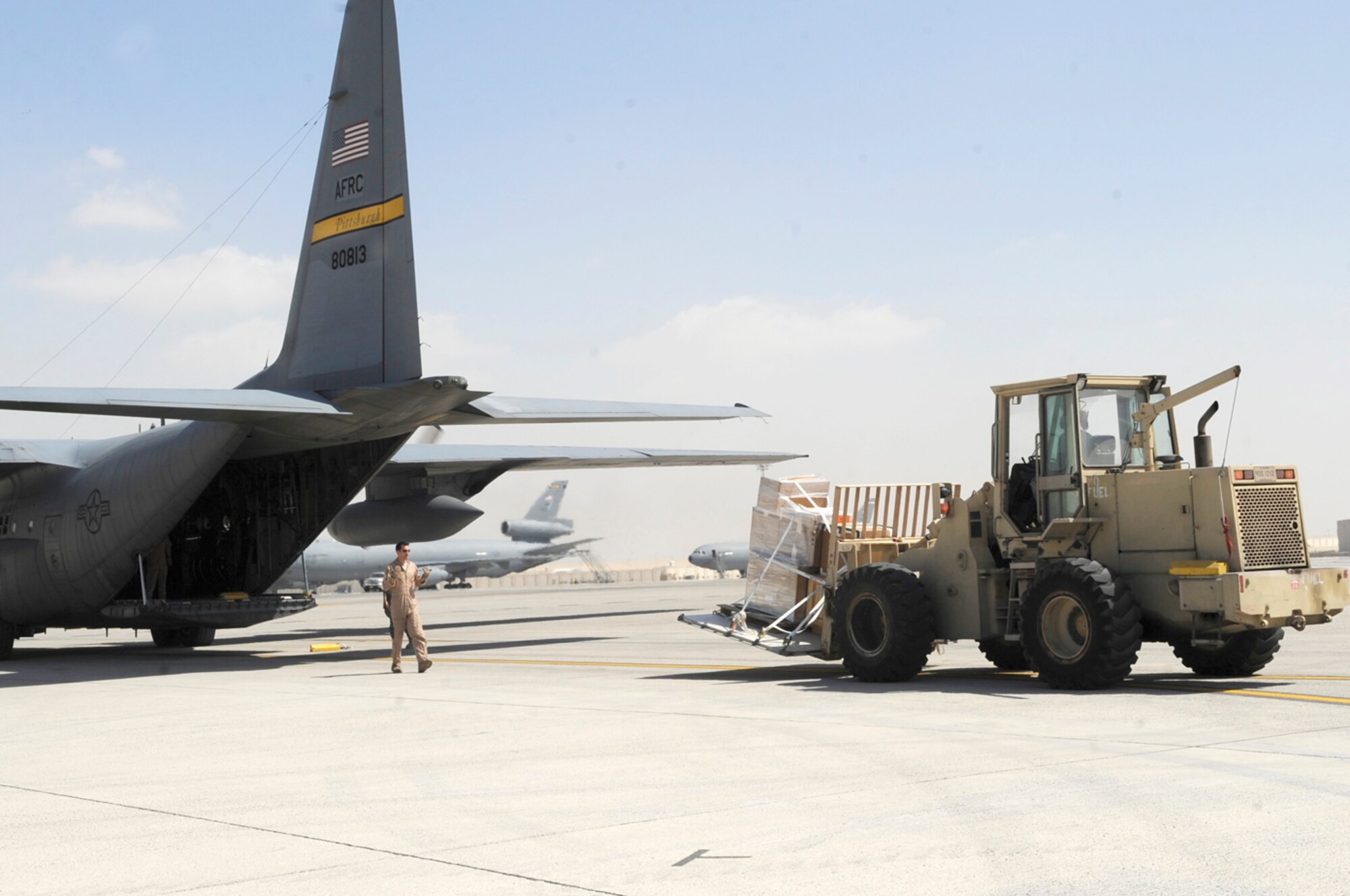 A deployed Air Force Reserve crew from the 911th Airlift Wing, Pittsburgh Air Reserve Station, Pa. performs inter-theater airlift using their C-130H Hercules in support of Operations Enduring and Iraqi Freedom. Shown here, they stop at an undisclosed base in Southwest Asia to pick up cargo. The Pittsburgh Airmen, attached to the 379th Air Expeditionary Wing at undisclosed base in Southwest Asia, supports the ground battle in Marjah, Afghanistan, and elsewhere by delivering vital assets, ground equipment and personnel - anything and everything needed to support the ground war. This C-130H was hand painted with a Pittsburgh Pirates' mural upon its nose to show its Pittsburgh Spirit as it flies combat missions throughout Southwest Asia waving a yellow tail-banner with the words Pittsburgh scrawled in black.  Team Pittsburgh consists of multiple aircrew, aircraft, as well as numerous maintenance and support personnel. (U.S. Air Force Photo/Capt. Cathleen Snow)
