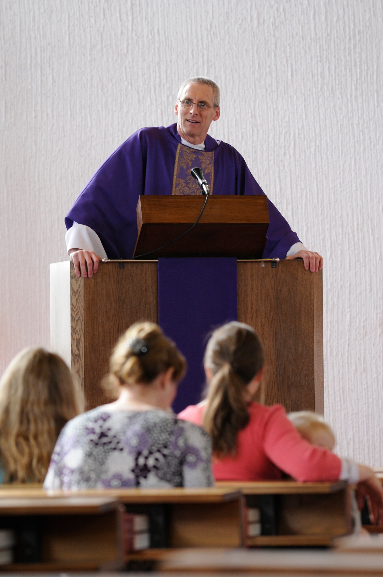 Capt. David McGuire, Chaplain, 86th Airlift Wing, preaches to a congregation in the North Side Chapel, Ramstein Air Base, Germany, Feb. 25, 2010. Capt. McGuire was a pastor for The Catholic Diocese of Richmond, Va., before joining the Air Force in 2007. "I wanted to contribute and help active duty members and their families," said Capt. McGuire. (U.S. Air Force photo by Airman 1st Class Brittany Perry)