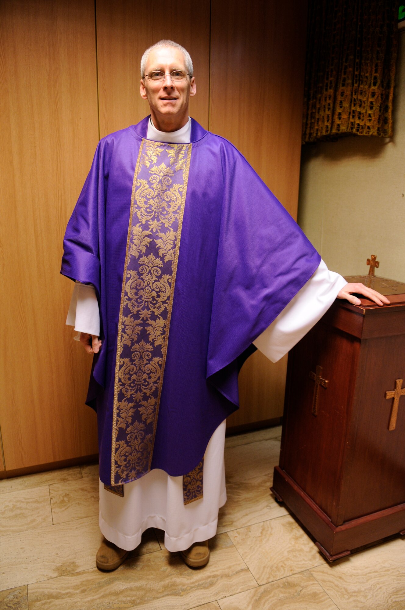Capt. David McGuire, Chaplain, 86th Airlift Wing, poses for a photo in the North Side Chapel, Ramstein Air Base, Germany, Feb. 25, 2010. Capt. McGuire was a pastor for The Catholic Diocese of Richmond, Va., before joining the Air Force in 2007. "I wanted to contribute and help active duty members and their families," said Capt. McGuire. (U.S. Air Force photo by Airman 1st Class Brittany Perry)