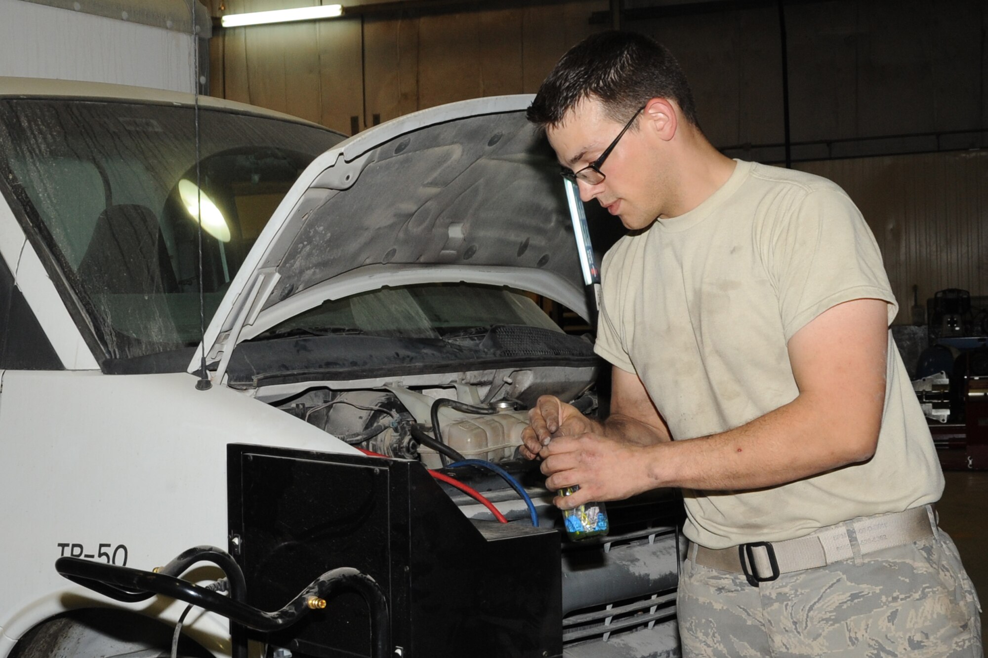 Staff Sgt. Andrew Parten, 380th Expeditionary Logistics Readiness Squadron vehicle technician, cleans up tools after fixing an air conditiontioning system on a van at an undisclosed location in Southwest Asia on Feb. 27, 2010. Sergeant Parten is deployed from the 142nd LRS Portland, Air National Guard and hails from Portland Oregon. The 380th AEW is comprised of four groups and 12 squadrons and the wing's deployed mission includes air refueling, surveillance and reconnaissance in support of overseas contingency operations in Southwest Asia. The wing supports operations Iraqi Freedom and Enduring Freedom and the Combined Joint Task Force-Horn of Africa. (U.S. Air Force photo/Senior Airman Jenifer H. Calhoun/Released)
