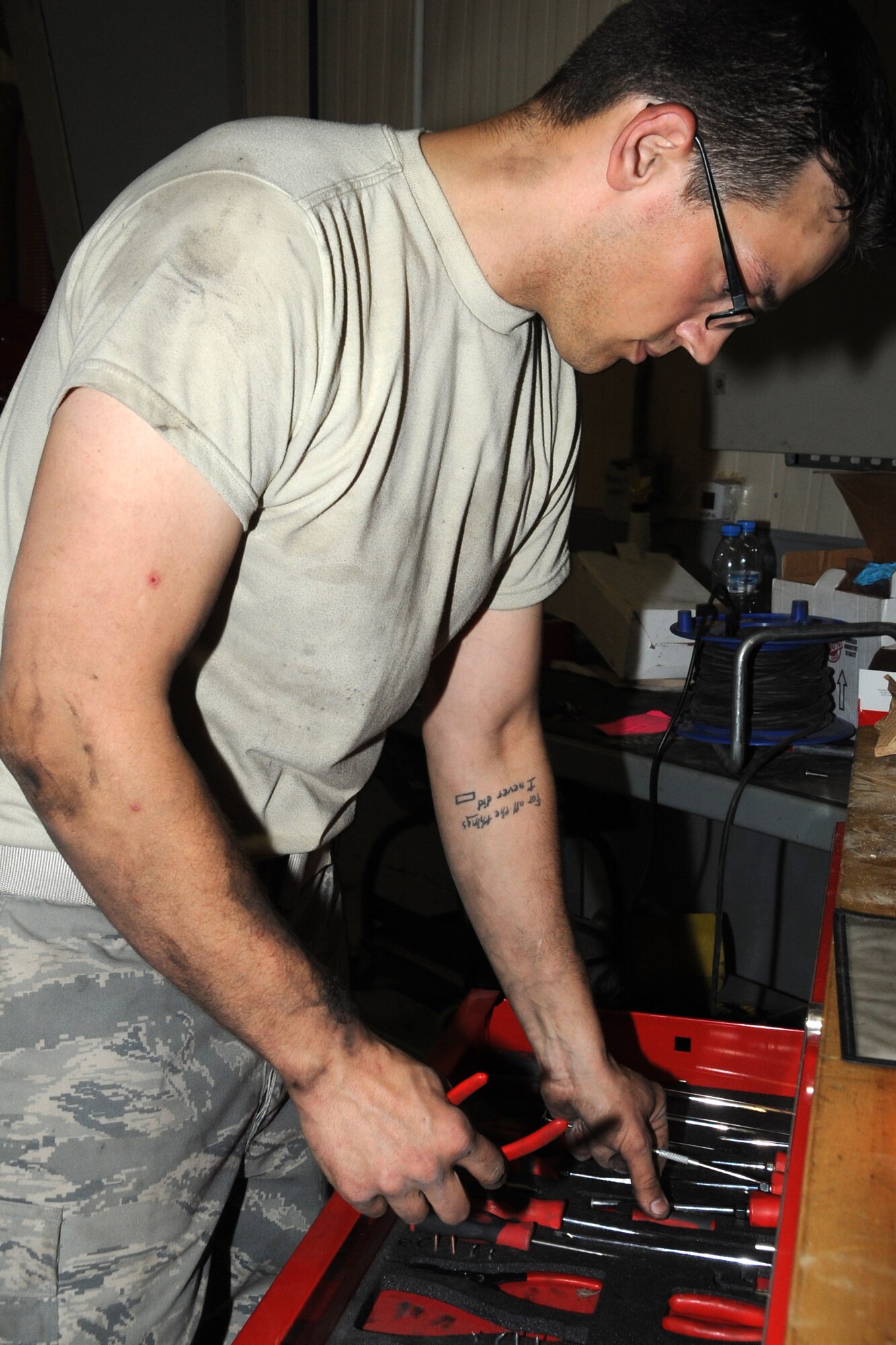 Staff Sgt. Andrew Parten, 380th Expeditionary Logistics Readiness Squadron vehicle technician, changes tools while working on an air conditioning unit on a van at an undisclosed location in Southwest Asia on Feb. 27, 2010. Sergeant Parten is deployed from the 142nd LRS Portland, Air National Guard and hails from Portland Oregon. The 380th AEW is comprised of four groups and 12 squadrons and the wing's deployed mission includes air refueling, surveillance and reconnaissance in support of overseas contingency operations in Southwest Asia. The wing supports operations Iraqi Freedom and Enduring Freedom and the Combined Joint Task Force-Horn of Africa. (U.S. Air Force photo/Senior Airman Jenifer H. Calhoun/Released)
