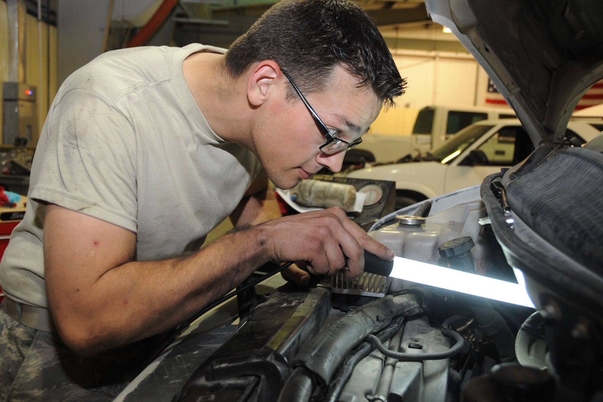 Staff Sgt. Andrew Parten, 380th Expeditionary Logistics Readiness Squadron vehicle technician, fixes an air conditiontioning system on a van at an undisclosed location in Southwest Asia on Feb. 27, 2010. Sergeant Parten is deployed from the 142nd LRS Portland, Air National Guard and hails from Portland Oregon. The 380th AEW is comprised of four groups and 12 squadrons and the wing's deployed mission includes air refueling, surveillance and reconnaissance in support of overseas contingency operations in Southwest Asia. The wing supports operations Iraqi Freedom and Enduring Freedom and the Combined Joint Task Force-Horn of Africa. (U.S. Air Force photo/Senior Airman Jenifer H. Calhoun/Released)
