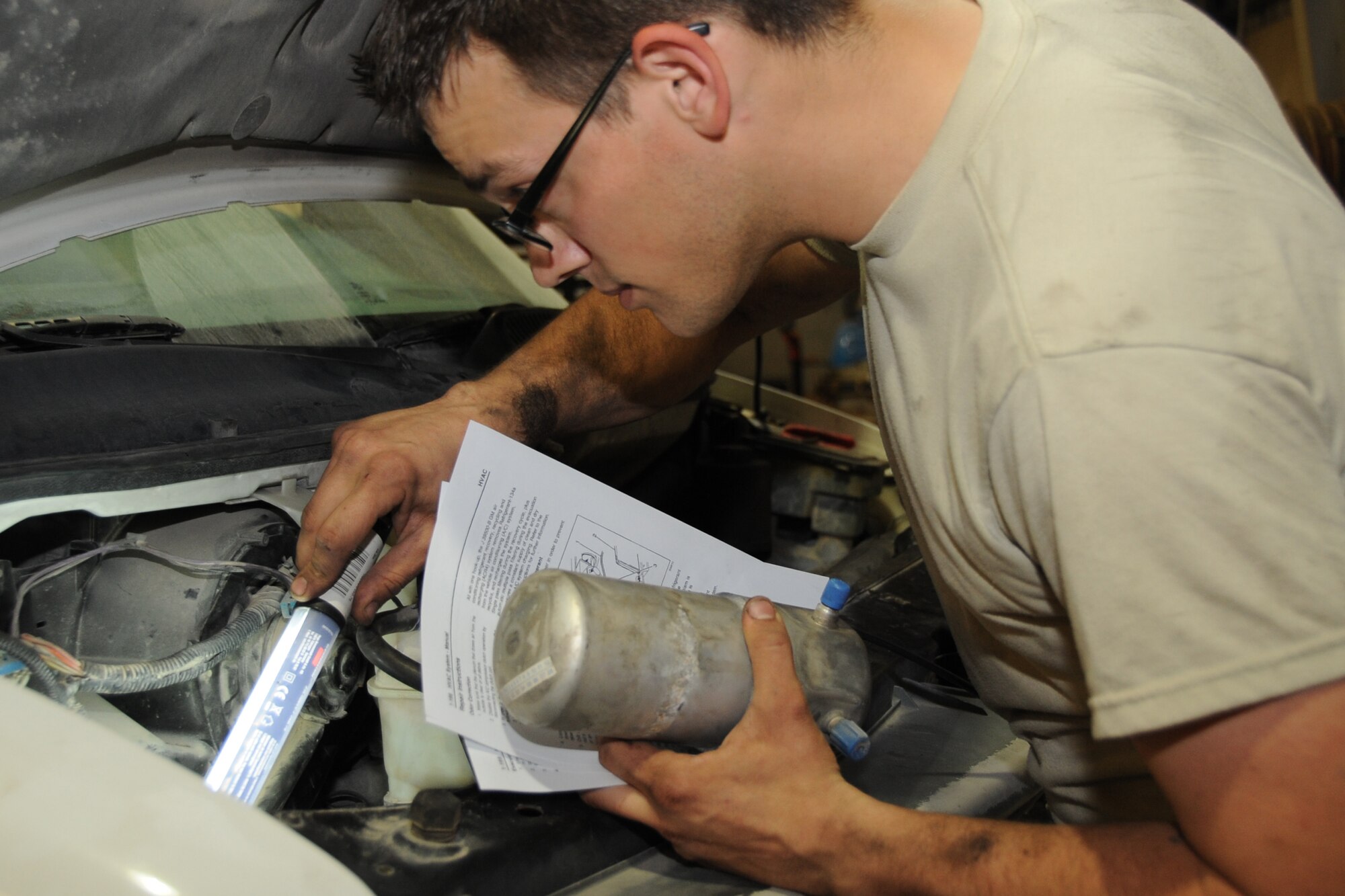 Staff Sgt. Andrew Parten, 380th Expeditionary Logistics Readiness Squadron vehicle technician, fixes an air conditiontioning system on a van at an undisclosed location in Southwest Asia on Feb. 27, 2010. Sergeant Parten is deployed from the 142nd LRS Portland, Air National Guard and hails from Portland Oregon. The 380th AEW is comprised of four groups and 12 squadrons and the wing's deployed mission includes air refueling, surveillance and reconnaissance in support of overseas contingency operations in Southwest Asia. The wing supports operations Iraqi Freedom and Enduring Freedom and the Combined Joint Task Force-Horn of Africa. (U.S. Air Force photo/Senior Airman Jenifer H. Calhoun/Released)
