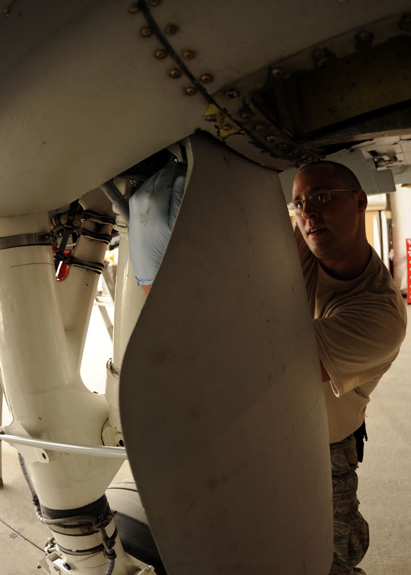 Tech. Sgt. Shawn Thorne, 451st Expeditionary Maintenance Squadron, performs routine maintenance check on the wheel well of an A10 thunderbolt II here Feb. 24.  (U.S. Air Force photo by Senior Airman Nancy Hooks/Released)