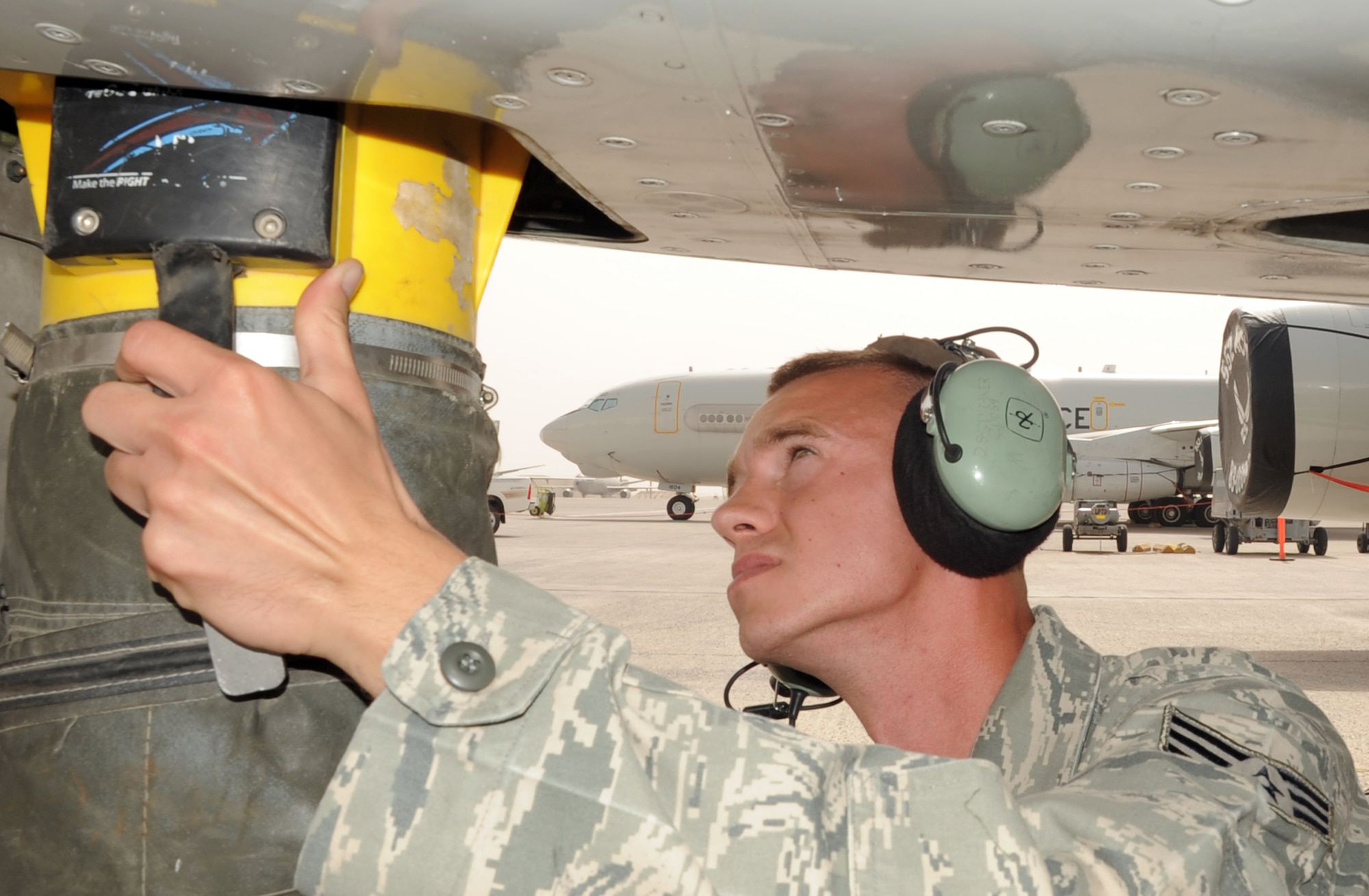 Senior Airman Daniel Shoemaker, an E-3 Sentry Airborne Warning and Control System aircraft electrical and environmental systems journeyman deployed with the 380th Expeditionary Aircraft Maintenance Squadron?s Sentry aircraft maintenance unit at a non-disclosed base in Southwest Asia, places a ventilation hose on an E-3 during operations at his deployed base March 1, 2010. As an electrical and environmental systems journeyman, Airman Shoemaker inspects, troubleshoots and maintains aircraft electrical and environmental systems, subsystems, components and associated test equipment. He is deployed from the 552nd Aircraft Maintenance Squadron at Tinker Air Force Base, Okla., and his hometown is Waxahachie, Texas. (U.S. Air Force Photo/Master Sgt. Scott T. Sturkol/Released)