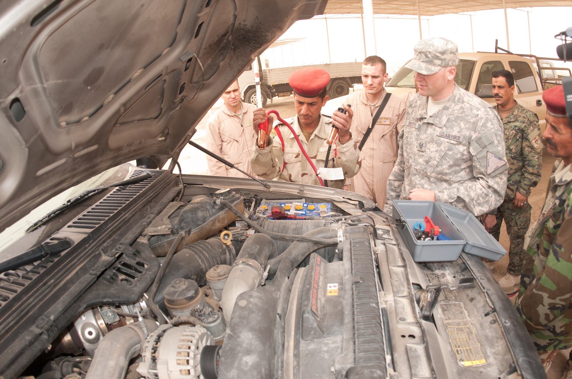 U.S. Air Force Tech Sgt. Scott Preston, a joint expeditionary tasked (JET) Airmen with the Logistics Military Advisory Team tests one of the Iraqi Army student on the sequential placing of jumper cables on a charged battery during a training course given by the LMAT at Camp Ur, Iraq, Feb. 22, 2010. Sgt Fish is from Natchitoches, La. (Photo by Senior Master Sgt. Elizabeth Gilbert/released)