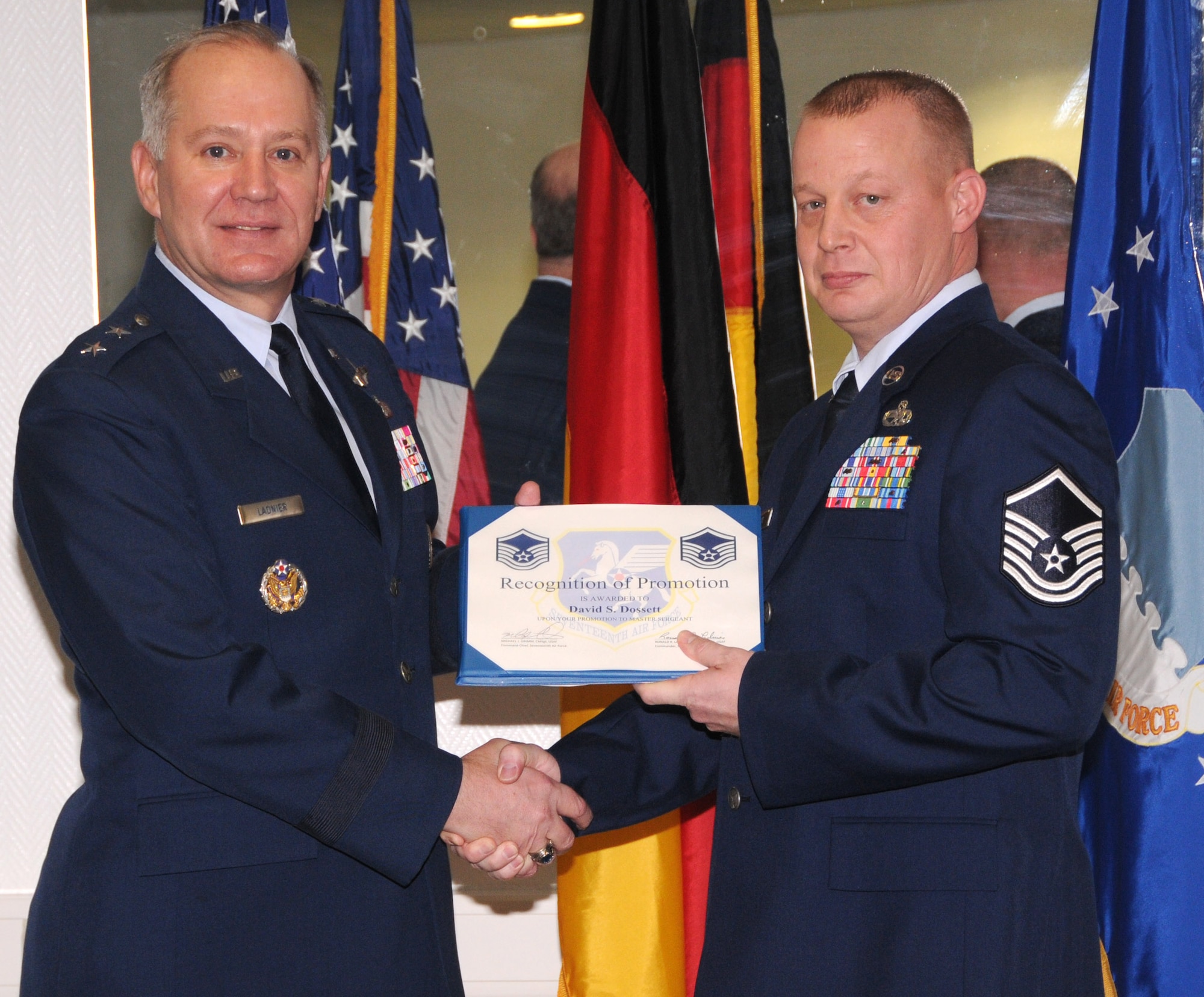 Master Sgt. David Dossett receives his promotion certificate from Maj. Gen. Ronald Ladnier, 17th Air Force commander, during his ceremony here Feb. 26. Sergeant Dossett is the 17th Air and Space Operations Center communication team section chief. (U.S. Air Force photo by Staff Sgt. Stefanie Torres)