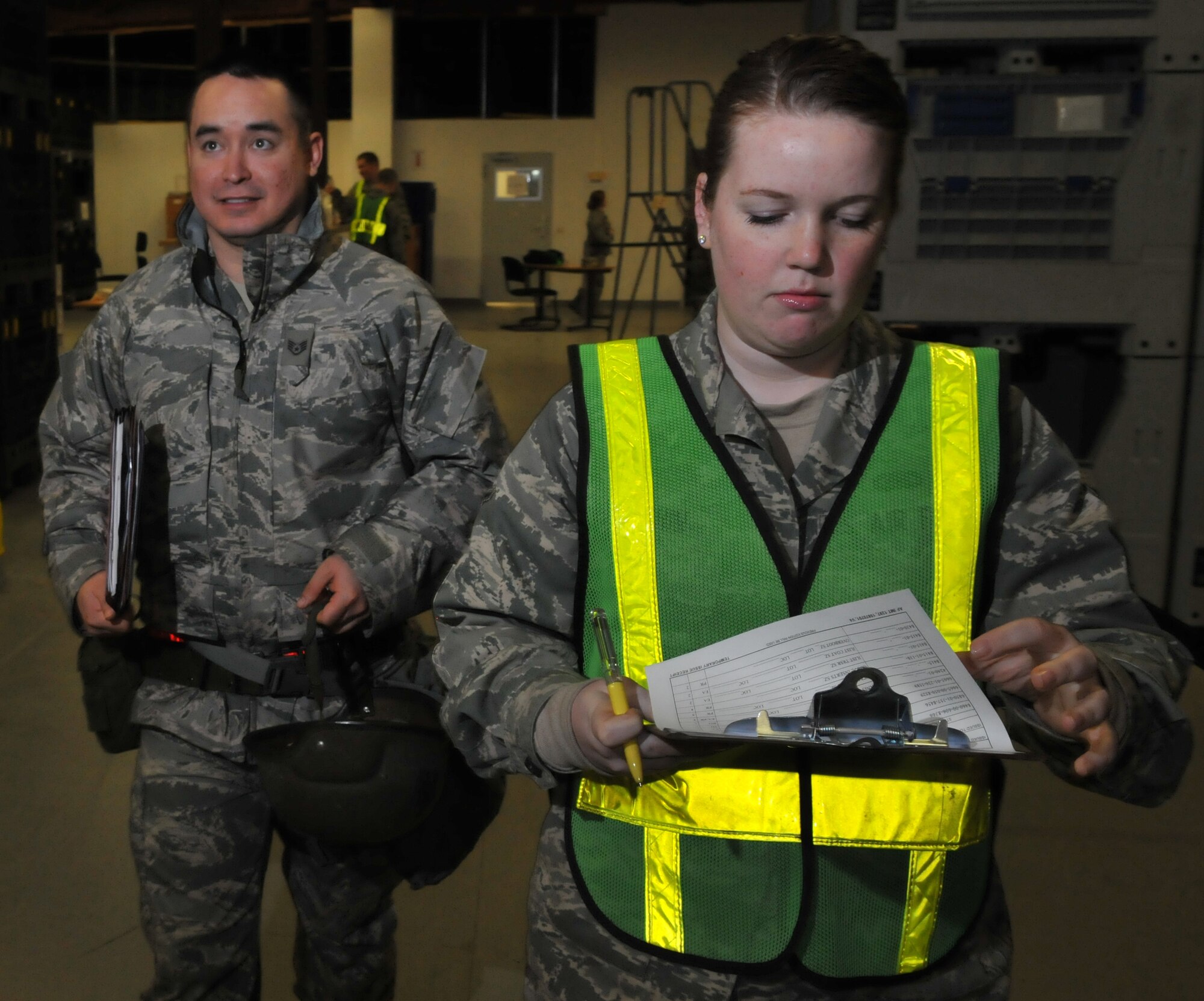 SPANGDAHLEM AIR BASE, Germany – Airman Jessica Melchin, 52nd Logistics Readiness Squadron supply journeyman, escorts Staff Sgt. Ronald Armstrong, 52nd Operations Support Squadron aircrew flight equipment technician, through a simulated personnel deployment function line to pick up his mobility gear during a Phase I operational readiness exercise Feb. 25. The exercise evaluated the 52nd Fighter Wing’s ability to prepare for a real-world rapid deployment of personnel and assets to a forward-operating base.  The PDF line is part of the pre-deployment checklist Airmen must go through to ensure they have all the proper documentation, medical clearances and requirements to deploy. (U.S. Air Force photo/Airman 1st Class Nick Wilson)
