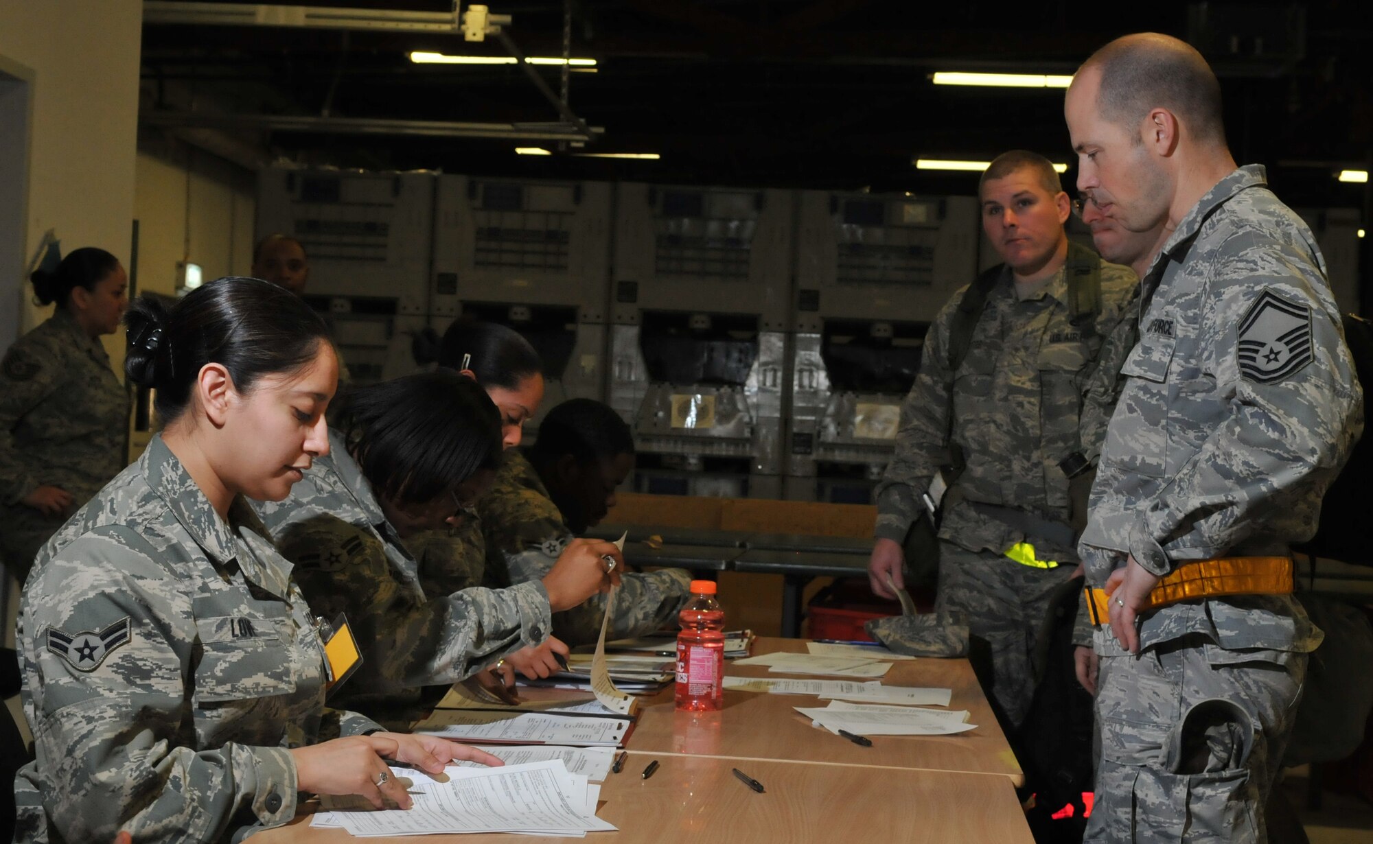 SPANGDAHLEM AIR BASE, Germany – Airman 1st Class Abigail Love, 52nd Force Support Squadron force management apprentice, processes Senior Master Sgt. William G. Moore, 52nd Component Maintenance Squadron superintendent, through a simulated personnel deployment function line during a Phase I Operational Readiness Exercise Feb. 25. The exercise evaluated the 52nd Fighter Wing’s ability to support short-notice deployments. The PDF line is part of the pre-deployment checklist Airmen must go through to ensure they have all the proper documentation, medical clearances and requirements to deploy. (U.S. Air Force photo/Airman 1st Class Nick Wilson)
