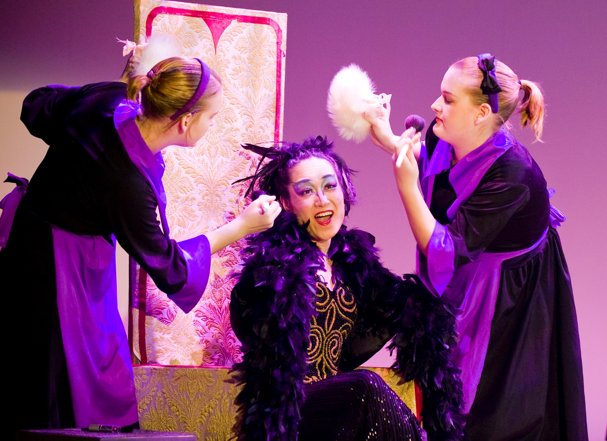 MISAWA CITY, Japan -- The Queen, played by Aiko Kudo, gets pampered by two of her maids, played by Lysa and Lyndsay McBride, during a musical rendition of "Snow White" Feb. 28 at the Misawa International Center. The aim of the musical was to promote cross-cultural relationships between Japanese and American children. (U.S. Air Force photo/Senior Airman Jamal D. Sutter)