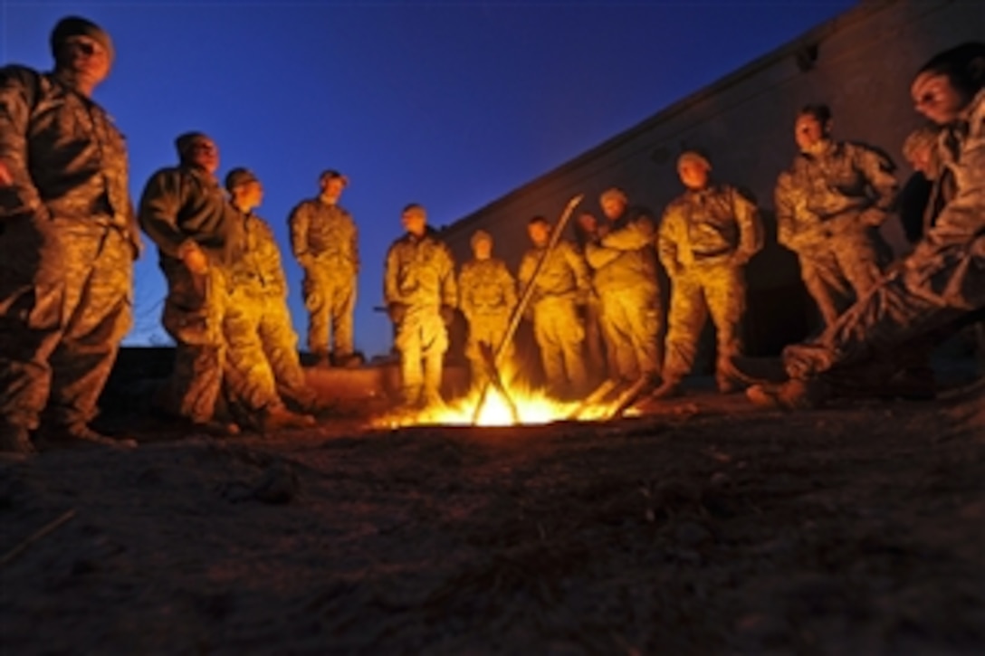 U.S. Army soldiers with Alpha Company, 1st Battalion, 17th Infantry Regiment gather around a fire to stay warm during an operation in the Helmand province of Afghanistan on Feb. 14, 2010.  