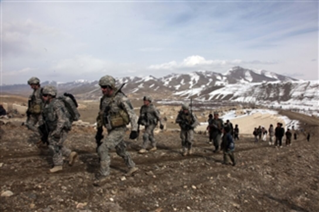 U.S. Army soldiers, from Alpha Company, 1st Battalion, 503rd Infantry Regiment, 173rd Airborne Brigade Combat Team, conduct a dismounted patrol near the village of Lwar while a group of local children follow along in Wardak province, Afghanistan, on Feb. 13, 2010.  Dismounted patrols are a great way to form friendly relationships with the locals.  
