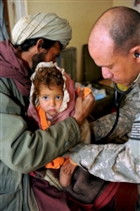U.S. Navy Lt. Joseph Baugh, a physician assistant with the Ghazni Provincial Reconstruction Team, provides medical care for a sick child during a village medical outreach mission at the Janda Clinic in the Gelan district of Afghanistan on Feb. 13, 2010.  Afghan, American and Polish medical providers from Forward Operating Base Ghazni treated 270 patients during the mission.  
