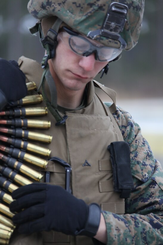 Lance Cpl Stephen M. Mauser, an MWSS-271 heavy equipment operator, shoulders ammunition for the M-2 .50 caliber heavy machine gun at Camp Lejeune. More than 50 Marines shot the M-2, the Mk-19 40 mm automatic grenade launcher and the M-240B medium machine gun during their weapons training exercise.