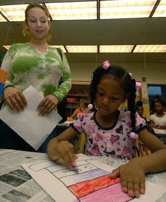 Mayra and Leilani Tolliver make Dr. Seuss hats during Kadena Elementary School's tribute to Dr. Seuss March 2. Dozens of students and parents celebrated the famous author's birthday with a series of games and activities including eating green eggs and ham. (Air Force photo/Staff Sgt. Jason Lake)