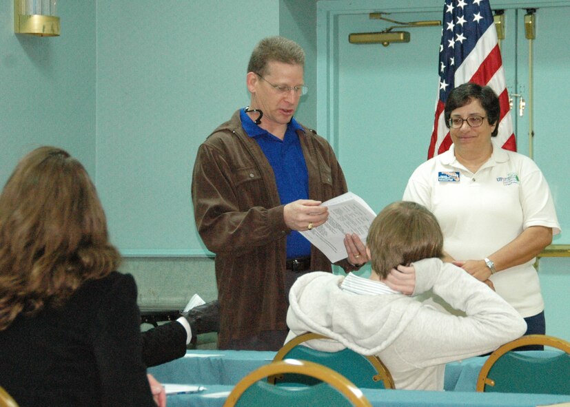 Air Force Reserve Master Sgt.  Steve Morgan, 919th Special Operations Wing Yellow Ribbon Reintegration Program director of cycle support, and Janet Psikogios, regional representative for Operation Military Kids, deliver an informational briefing for spouses of the wing’s deployed reservists at a Panama City Beach hotel conference center Feb. 27.   A Department of Defense initiative, the YRRP events provide information, services, referral and proactive outreach programs to Reserve and Guard Airmen and their families though all phases of the deployment cycle.  (U.S. Air Force photo/Maj. Terry Lisenbee)