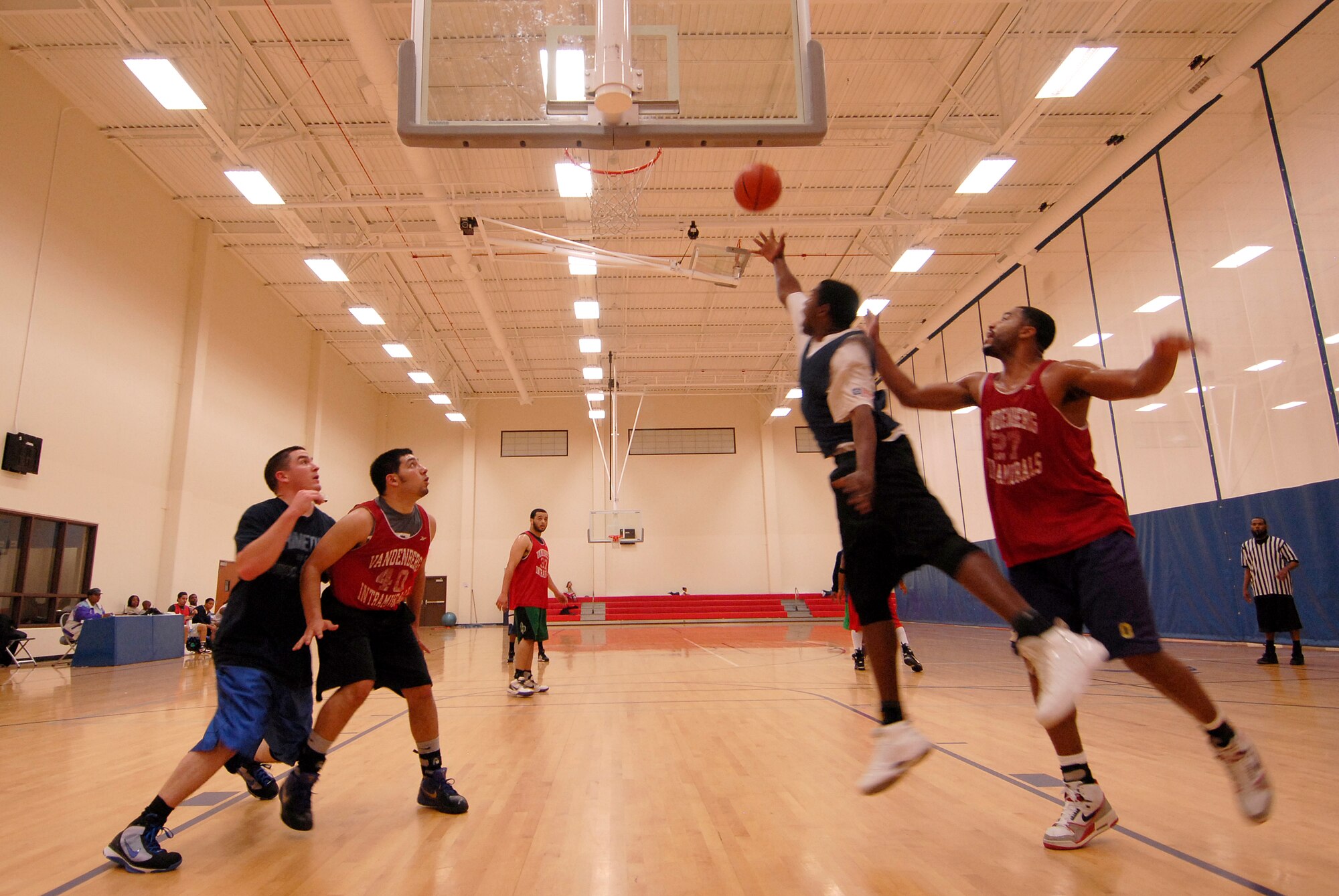VANDENBERG AIR FORCE BASE, Calif. -- Destry Taylor, a 30th Launch Group team member, soars to toss a layup at the Vandenberg Fitness Center here Monday, March 1, 2010.  The 30th LCG took the game, winning 64-60.  (U.S. Air Force photo/Senior Airman Andrew Satran) 

 
 
 
 
 
 