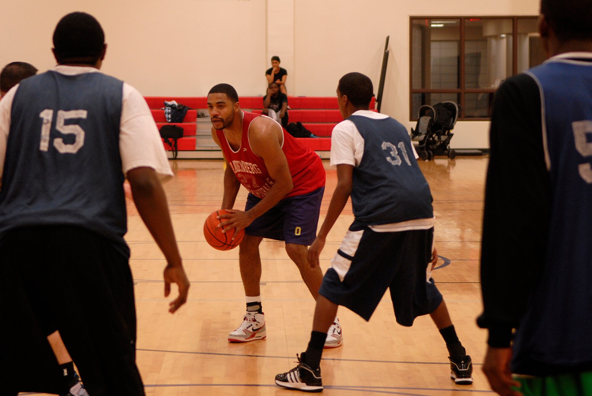 VANDENBERG AIR FORCE BASE, Calif. -- Waiting to make a pass, Joel Smith, a 30th Medical Group team member, looks to find an open man at the Vandenberg Fitness Center here Monday, March 1, 2010.  The 30th Launch Group took the game, winning 64-60.  (U.S. Air Force photo/Senior Airman Andrew Satran) 

 
 
 
 