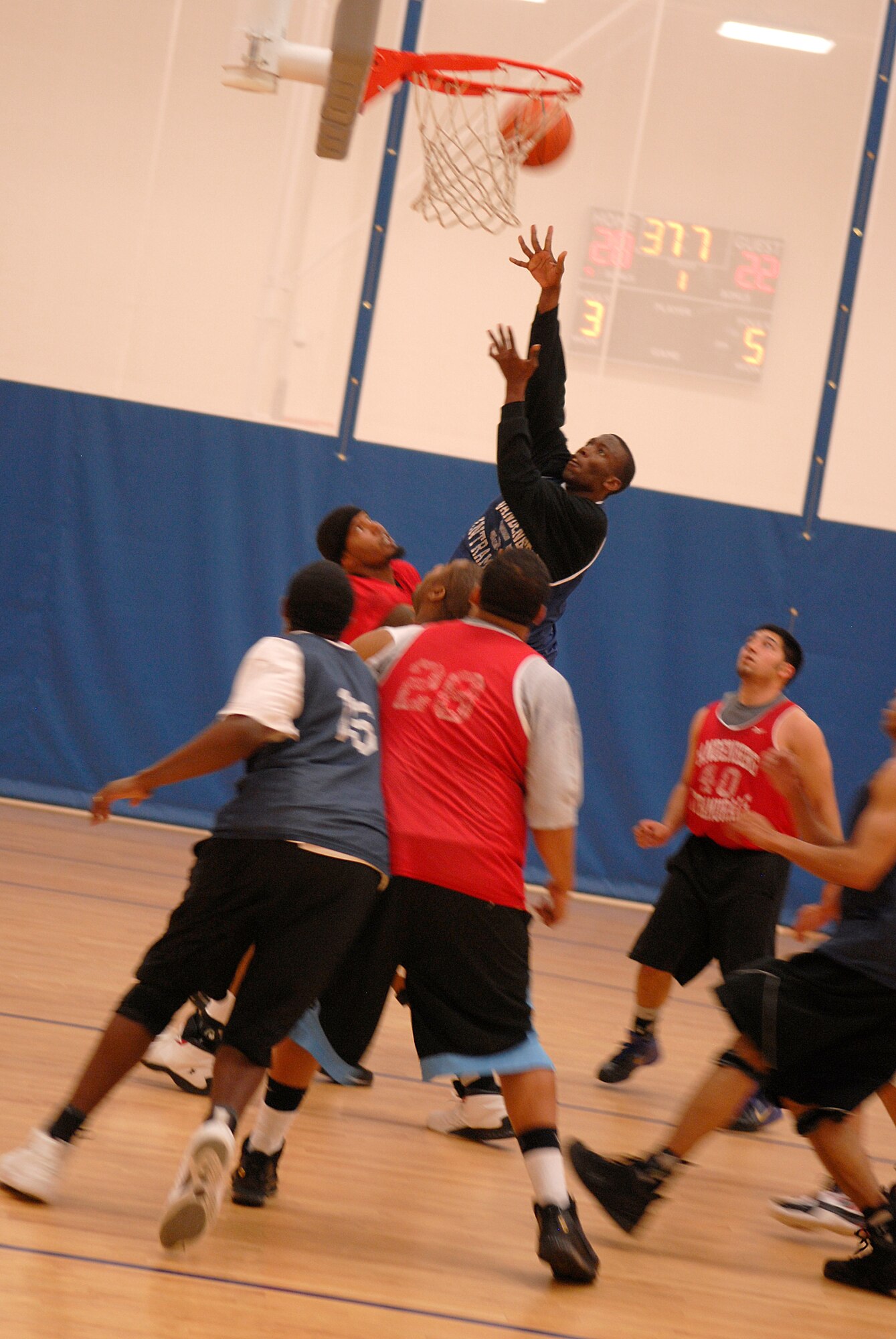 VANDENBERG AIR FORCE BASE, Calif. -- Pushing through his opponents, Anthoney Kilgore, a 30th Launch Group team member, shoots a layup at the Vandenberg Fitness Center here Monday, March 1, 2010.  The 30th LCG took the game, winning 64-60.  (U.S. Air Force photo/Senior Airman Andrew Satran) 

 
 
 