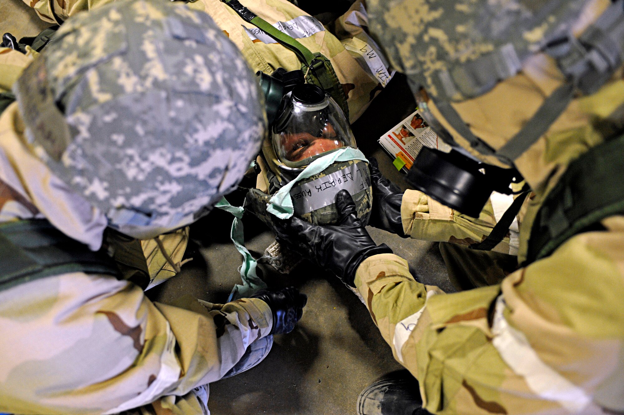 ELLSWORTH AIR FORCE BASE, S.D. -- (Left) Senior Airman Adrian Lizama, 28th Logistics Readiness Squadron vehicle maintenance technician, and Airman 1st Class Josh Dunn, 28 LRS vehicle maintenance technician, assemble a neck brace for an exercise "victim" during a Phase II Operational Readiness Exercise, March 2. The Phase II ORE tested Airmen across the base on their ability to operate in a deployed environment. (U.S. Air Force photo/Airman 1st Class Matthew Flynn)