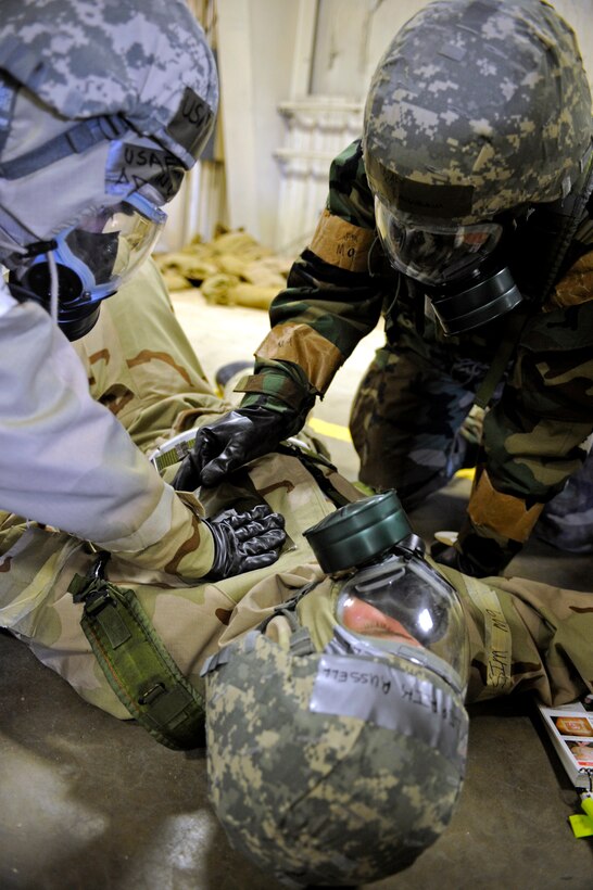 ELLSWORTH AIR FORCE BASE, S.D. -- (Left) Senior Airman Adrian Lizama, 28th Logistics Readiness Squadron vehicle maintenance technician, and Airman 1st Class Eric Laughbaum, 28 LRS vehicle maintenance technician, provide Self-Aid and Buddy Care to an exercise "victim," March 2. Airmen Lizama and Laughbaum participated in a Phase II Operational Readiness Exercise to test their ability to operate in a deployed environment. (U.S. Air Force photo/Airman 1st Class Matthew Flynn)
