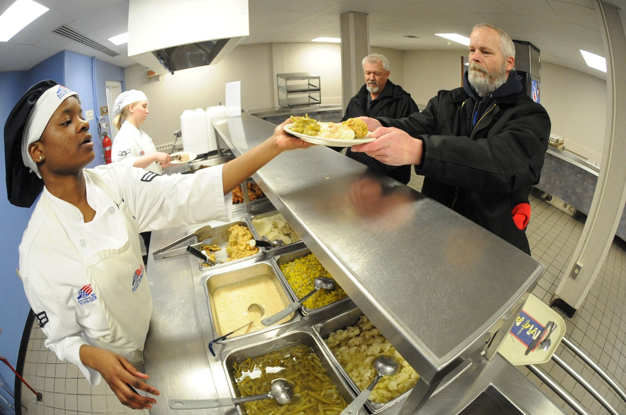 MINOT AIR FORCE BASE, N.D. – Airman 1st Class Tenisha Benton-Parker, 5th Force Support Squadron services apprentice, serves Robert Mintie, 91st Maintenance Operations Squadron production controller and Bryan Clarkson, 91st Maintenance Group resource advisor, at the Dakota Inn Dining Facility Mar 1. The Dakota Inn Dining Facility’s restoration was a $56,000 project that took place over a three-month period last summer. The complete restoration of the Dakota Inn is a high-efficiency energy and money saving project that will produce excellent environmental standards for Minot Air Force Base. (U.S. Air Force Photo by Senior Airman Jesse Lopez)