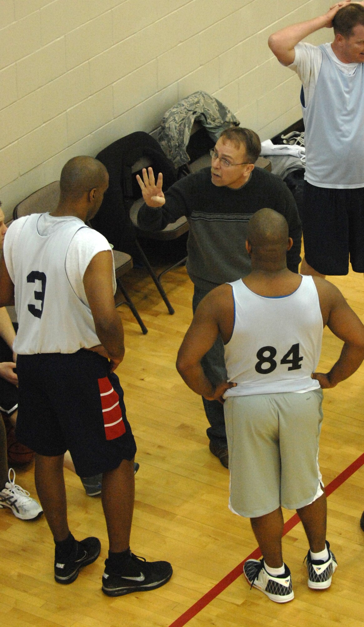 MINOT AIR FORCE BASE ND, -- William Large, 5th Medical Group assistant coach, motivates the team  during on a time-out at the McAdoo Fitness Center on Minot Air Force Base  Feb 24. The 5th MDG defeated the 91st Operations Group 48-30 and captured their third consecutive over 30 league championship. (U.S. Air Force photo by Airman 1st Class Aaron-Forrest Wainwright)