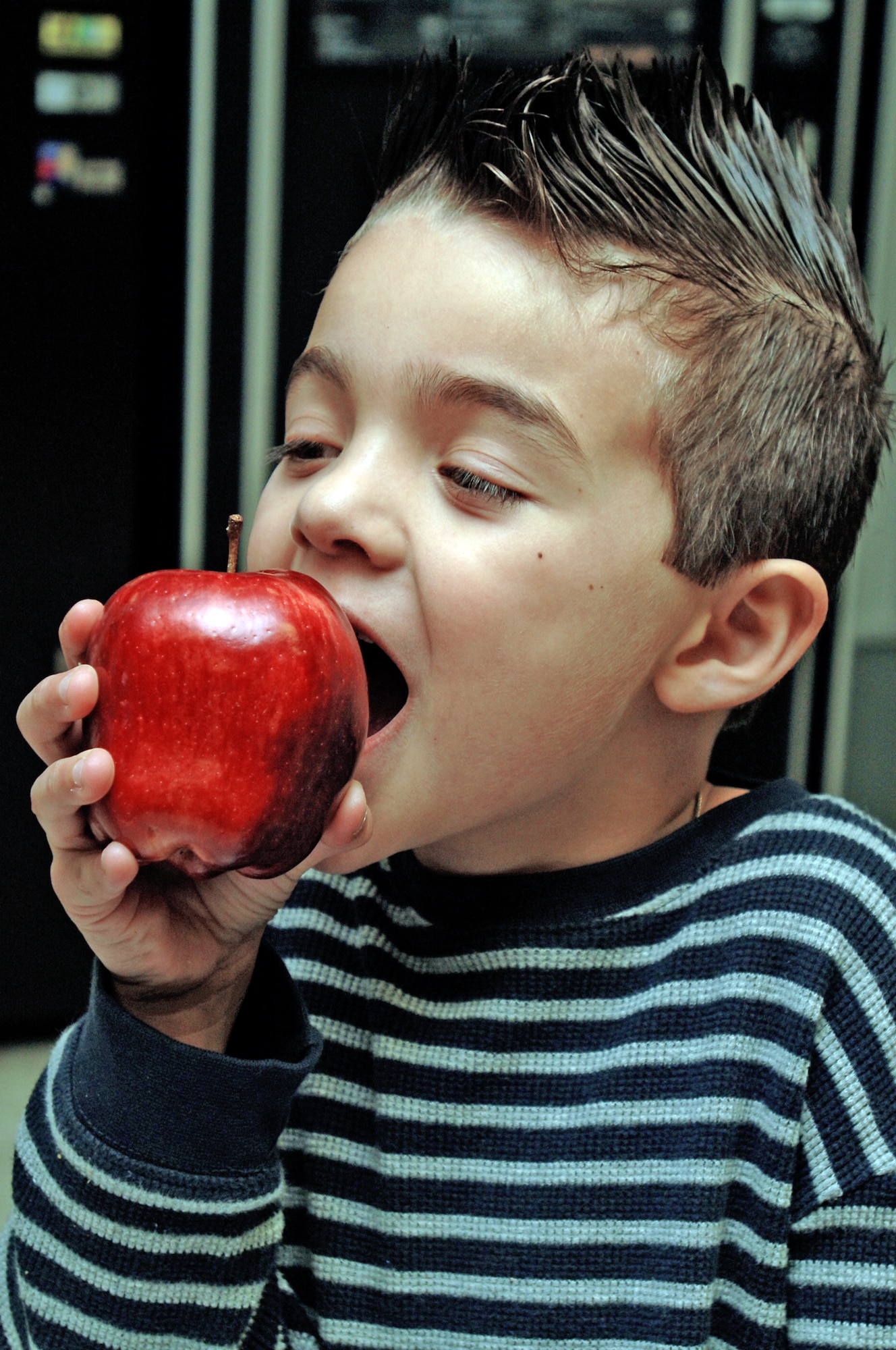 Angel Cuevas, son of Army Spc. Ana Cuevas from the Institute of Surgical Research at Fort Sam Houston, Texas, enjoys an apple at the Wilford Hall Medical Center Feb. 25, 2010, at Lackland Air Force Base, Texas. During National Nutrition Month, Airmen are encouraged to take time to assess their eating habits and how healthy eating habits are taught to children. (U.S. Air Force photo/Senior Airman Nicole Roberts)