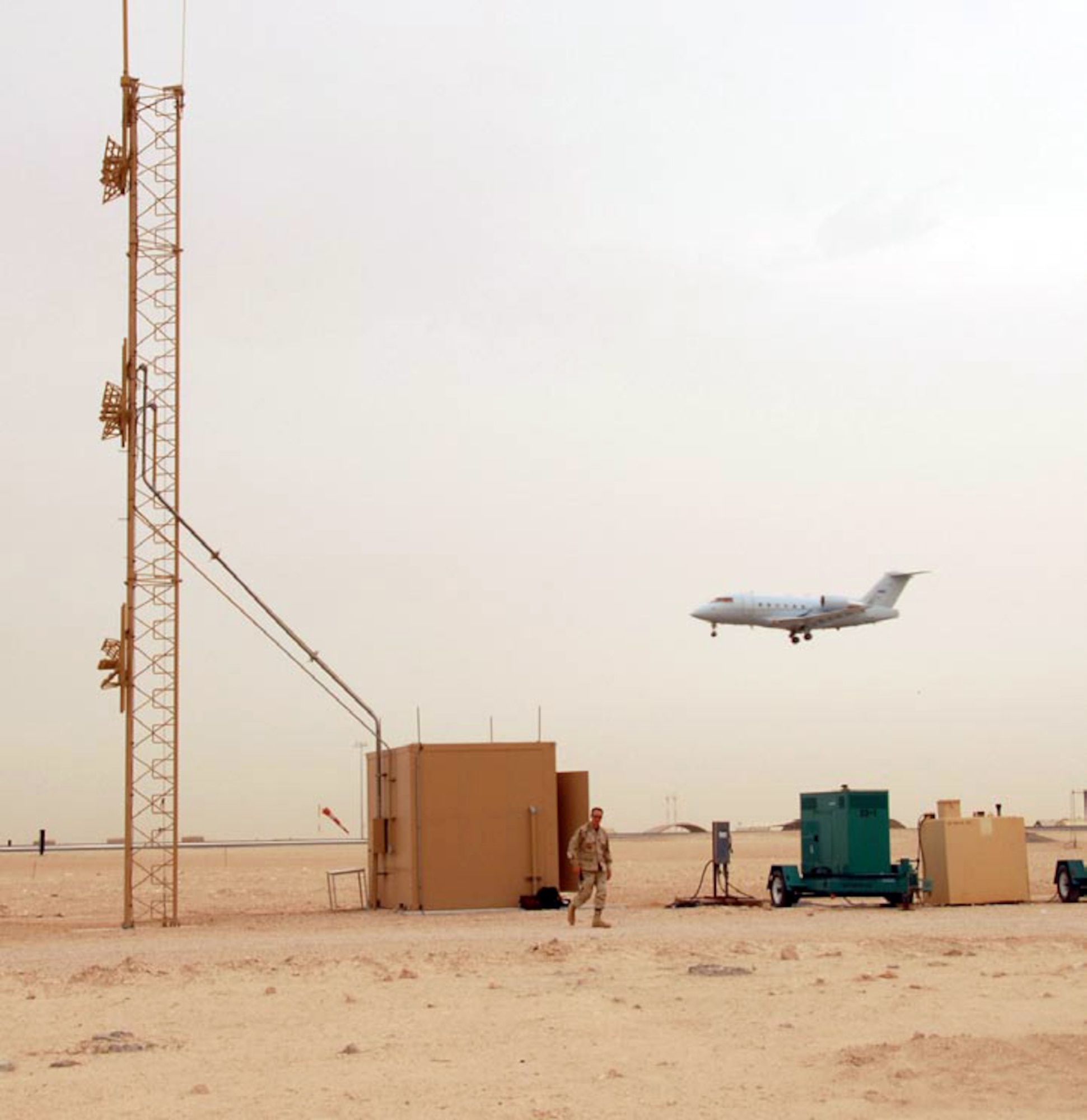 A modified CL-60 Challenger aircraft flies a low-level approach past an instrument landing system being used in 2007 in Southwest Asia. The 853rd Electronic Systems Group staff will soon be releasing a request for proposals for a deployable instrument landing system, which will be leaner and more transportable. (U.S. Air Force photo/Airman 1st Class Gustavo Gonzalez)