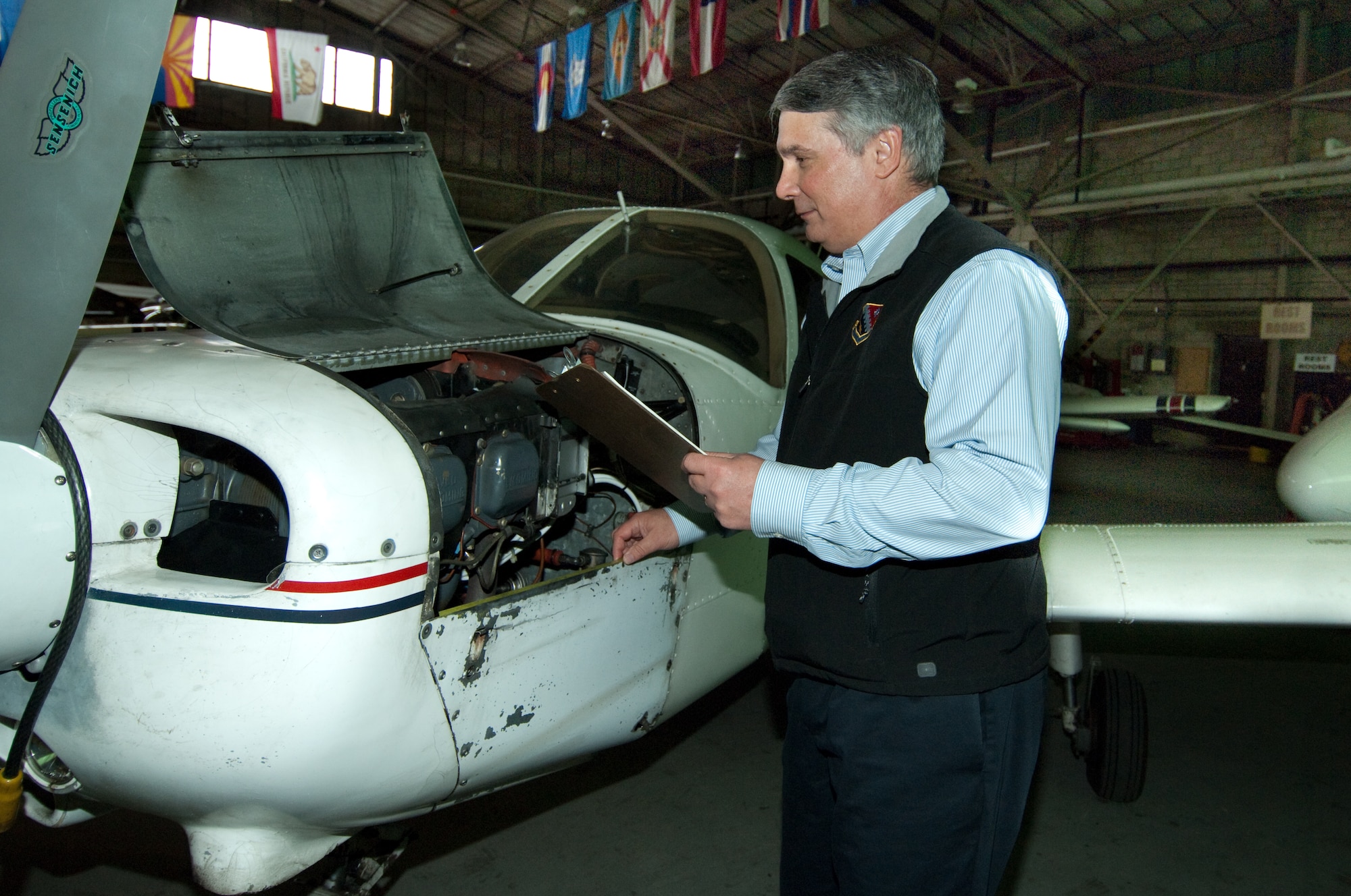 Hanscom Aero Club Manager Steve Bates checks the engine on one of the club's aircraft.  Mr. Bates is the Air Force Community Services Flight Manager of the Year.  (U.S. Air force photo by Rick Berry)