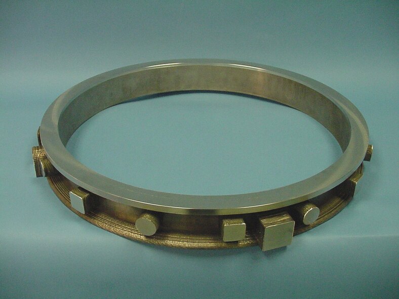 Pictured is a forged ring with representative features of a jet engine case added via electron-beam wire deposition.  The incorporation of these superalloy additive manufacturing methods into the production process has the potential for substantial reductions in engine cost and weight. (AFRL image)