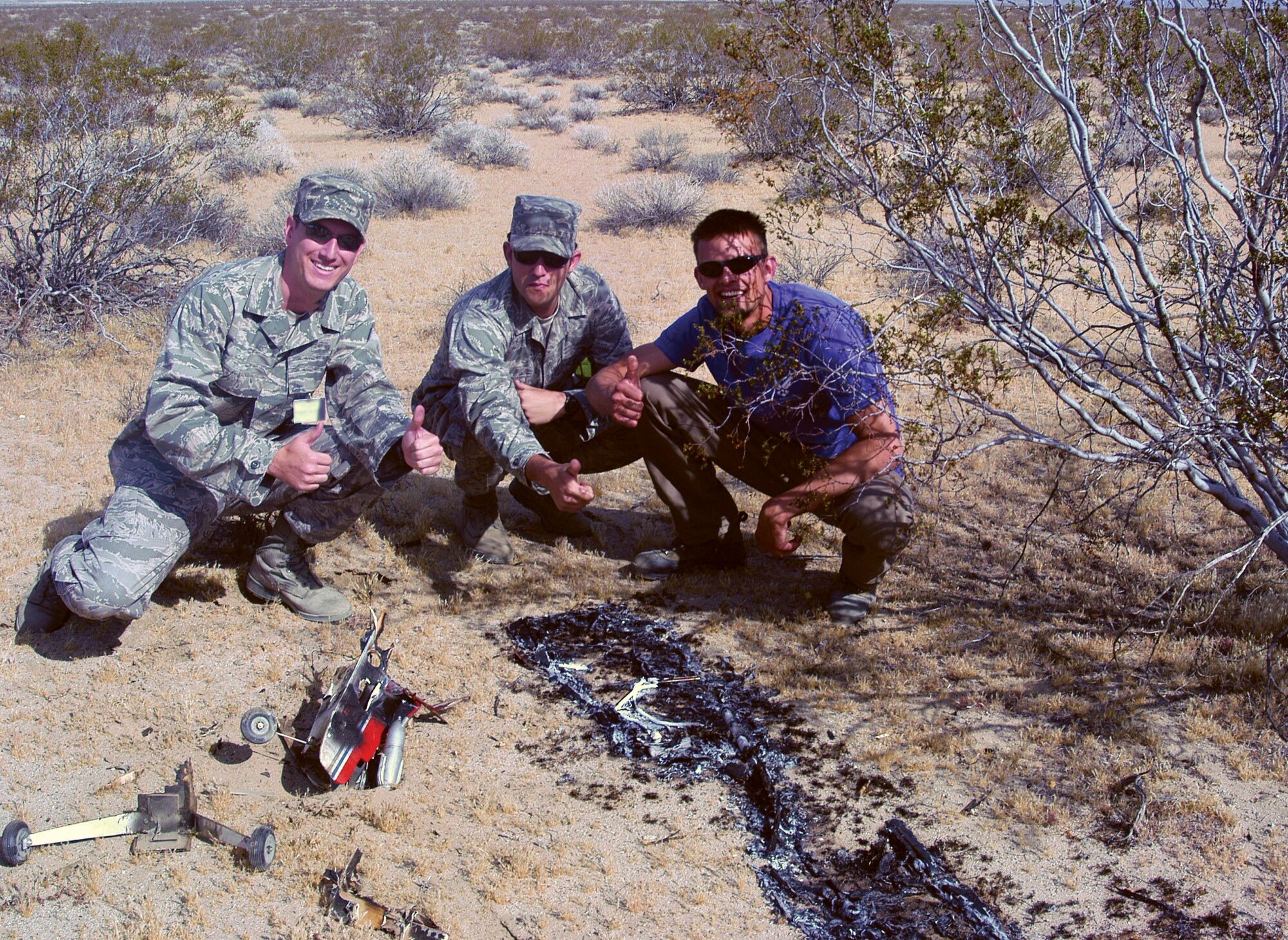 Pictured left to right are Air Force Research Laboratory counter unmanned aerial system demonstration participants Second Lieutenant Kyle Dufaud, 2nd Lt. Shon Neal and Mr. Nick Tarasenko as they observe a UAS crash site. (AFRL image)