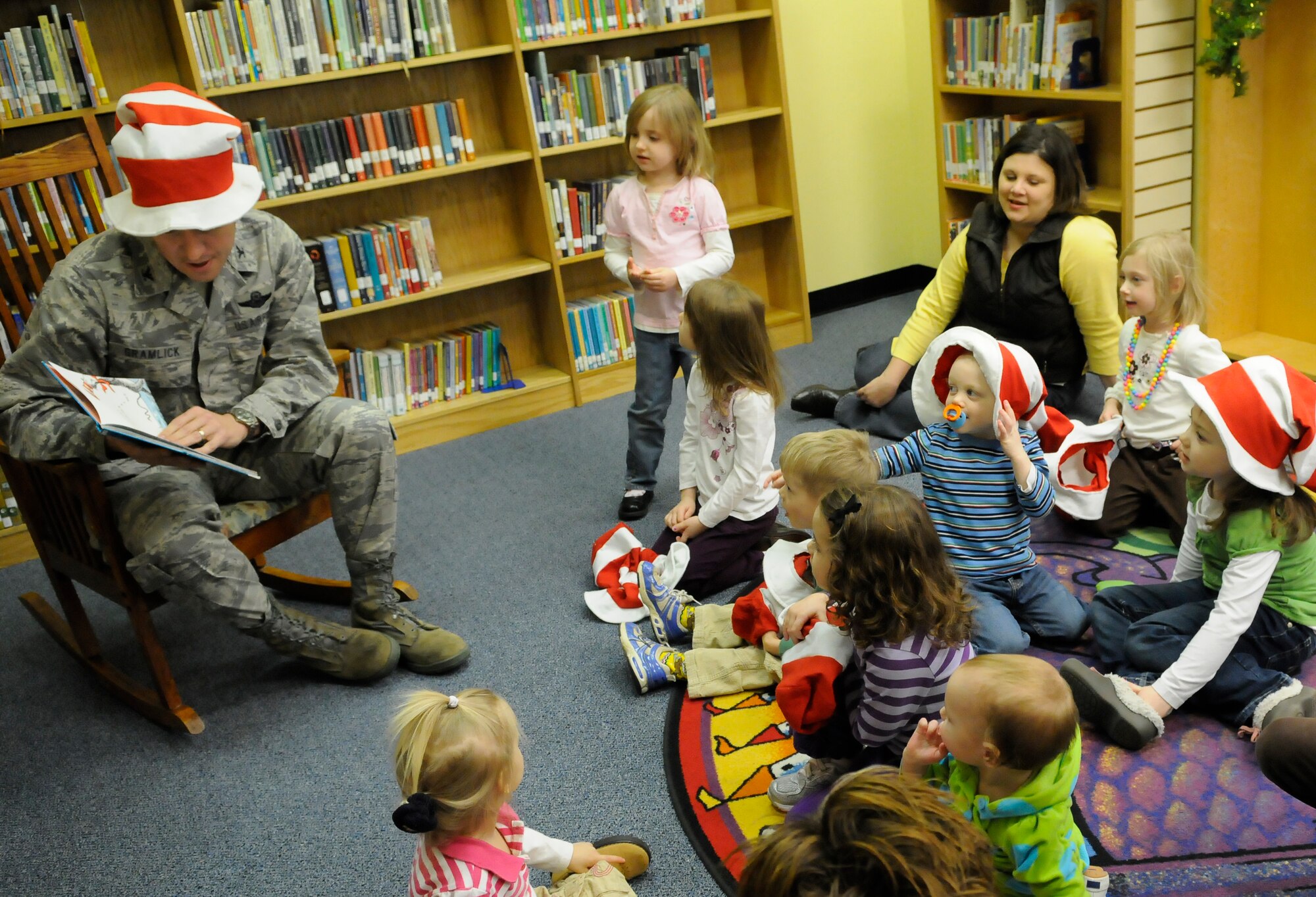 Colonel Carl Gramlick, 11th Wing Vice Commander, reads to the children of the Bolling community for Read Across America March 2 at the Bolling Air Force Base Library. Read Across America is an initiative on reading created by the National Education Association, and provides an opportunity for service members to interact with children and emphasize the importance of reading. (U.S. Air Force photo by Senior Airman Alexandre Montes)