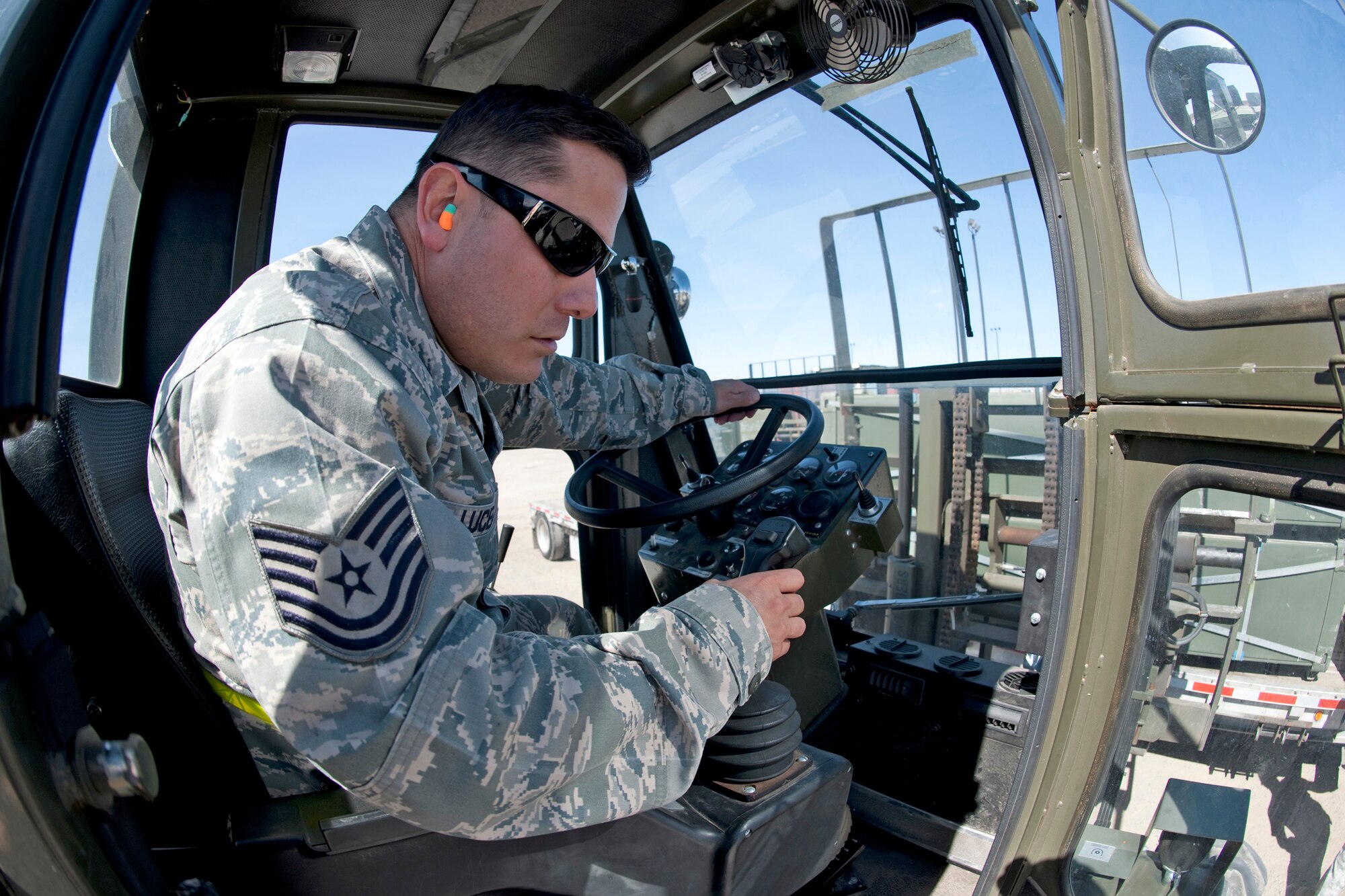 Tech. Sgt. Raymond Lucero uses a 13,000-pound loader to load nearly 11,000 pounds of AM-2 matting onto a flatbed trailer Feb. 24, 2010, at Holloman Air Force Base, N.M. Sergeant Lucero is a team leader with the 49th Materiel Maintenance Support Squadron. The 49th MMSS staff is deploying 480,000 square feet of the matting that will be assembled to create airstrips supporting joint and coalition forces throughout Afghanistan. (U.S. Air Force photo/Staff Sgt. Joe Laws)
