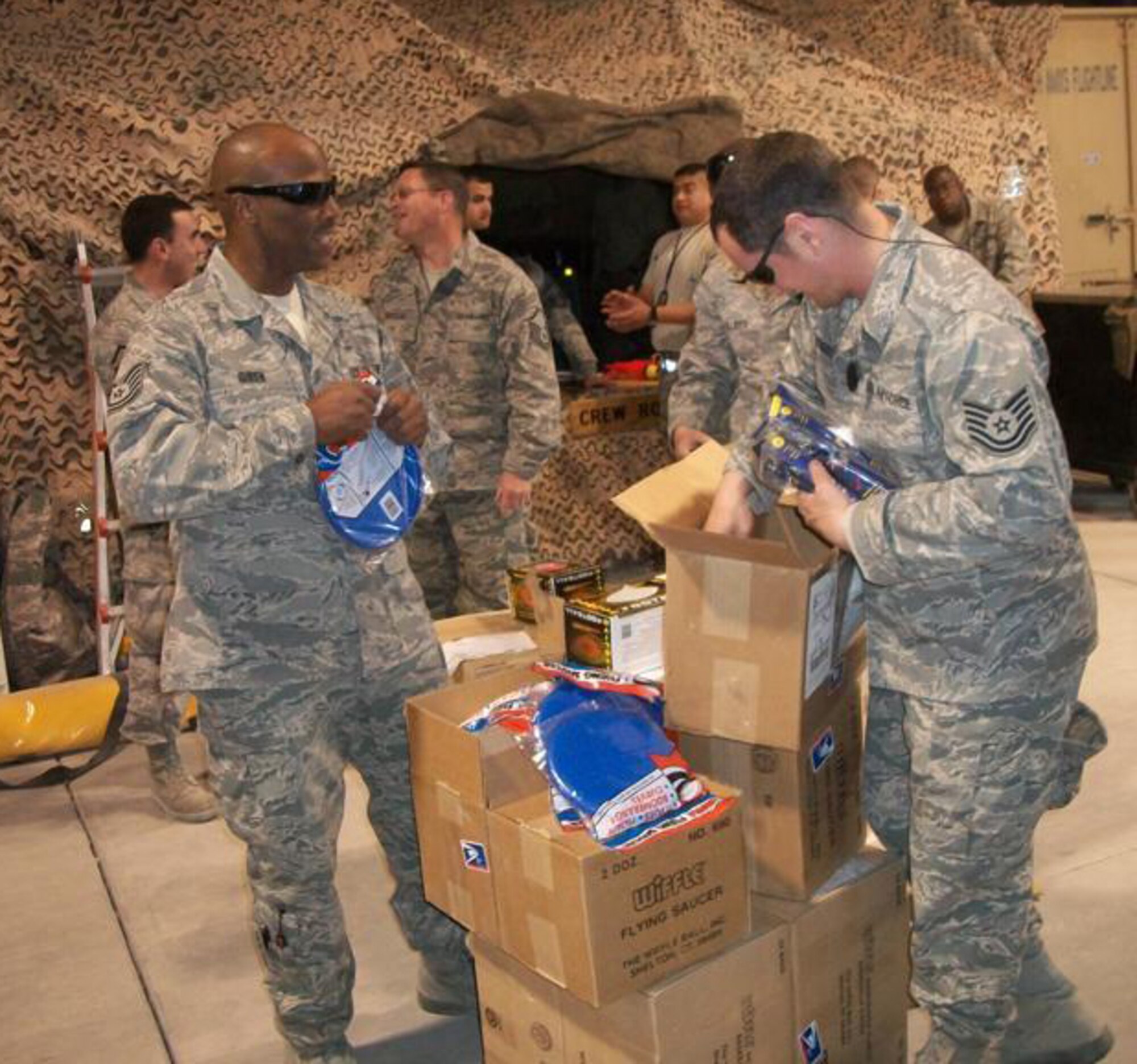 Members of the 188th Fighter Wing, based in Fort Smith, Ark., and the 175th Fighter Wing, based in Baltimore, Md., open care packages at Kandahar Airfield in Afghanistan Feb. 27, 2010. The boxes were filled with recreational items provided by Sarah Butler-Thorne, who raised more than $2,000 to help purchase the products. Butler-Thorne is the wife of Tech. Sgt. Shawn Thorne, a crew chief with the 188th. The 188th deployed 50 members to Kandahar Jan. 4 as part of an Aerospace Expeditionary Force rotation. The 188th will deploy approximately 250 additional Guardsmen in early March, when the unit's official rotation begins. (Photo by Tech. Sgt. Shawn Thorne/188th Fighter Wing)