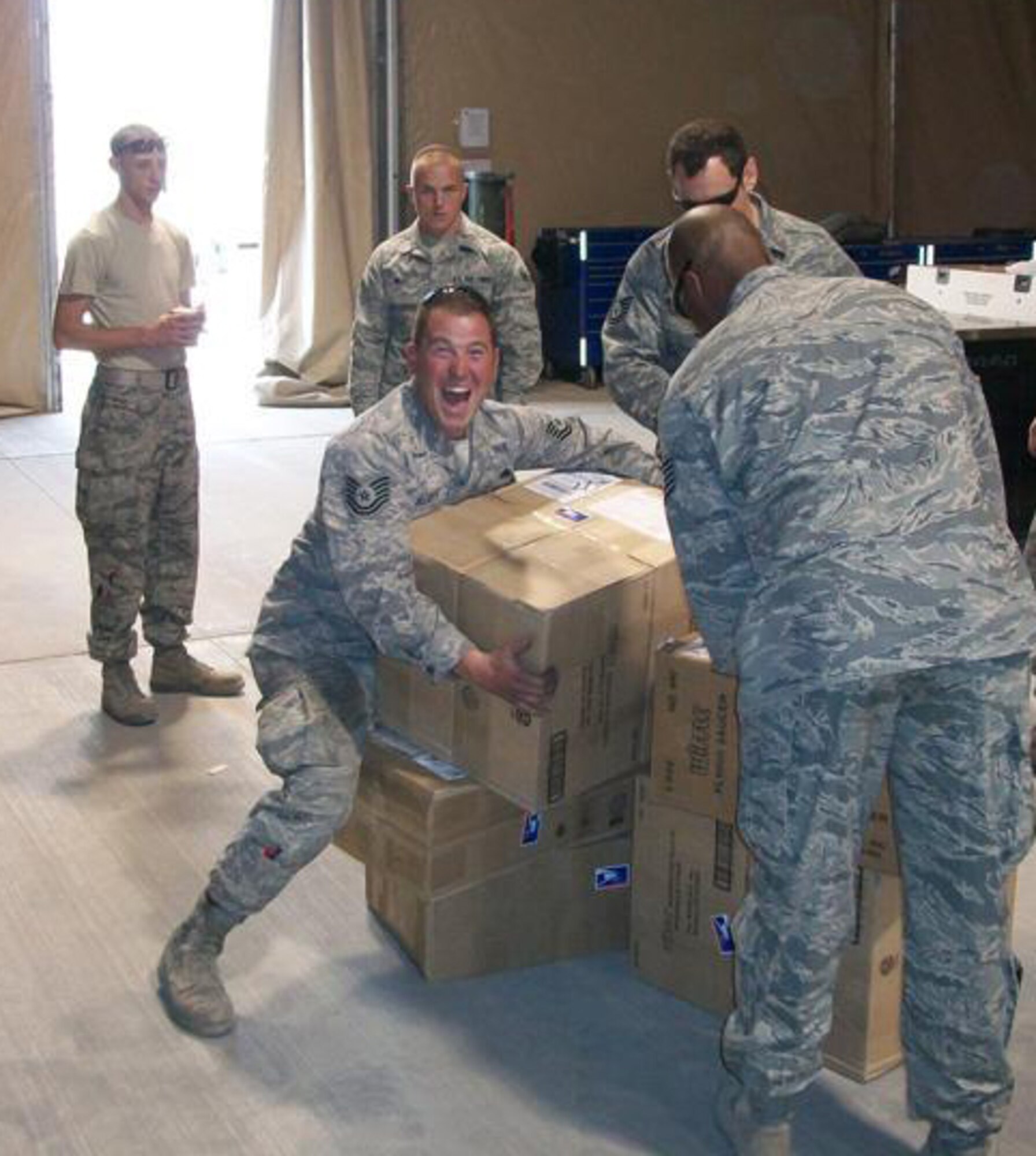 Members of the 188th Fighter Wing, based in Fort Smith, Ark., and the 175th Fighter Wing, based in Baltimore, Md., open care packages at Kandahar Airfield in Afghanistan Feb. 27, 2010. The boxes were filled with recreational items provided by Sarah Butler-Thorne, who raised more than $2,000 to help purchase the products. Butler-Thorne is the wife of Tech. Sgt. Shawn Thorne, a crew chief with the 188th. The 188th deployed 50 members to Kandahar Jan. 4 as part of an Aerospace Expeditionary Force rotation. The 188th will deploy approximately 250 additional Guardsmen in early March, when the unit's official rotation begins. (Photo by Tech. Sgt. Shawn Thorne/188th Fighter Wing)