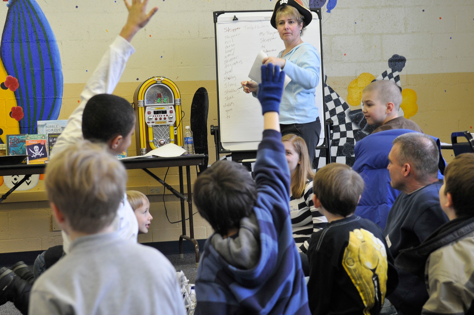 Kathleen Jacobson looks for a volunteer to contribute a word to the Mad Lib during the Guys Read Party Feb.27, 2010, Eielson Air Force Base. The Mad Lib used the parts of speech the boys thought of to create a wild story they were able to enjoy later. Ms. Jacobson is a base library technical technician. (U.S. Air Force photo/ Airman 1st Class Janine Thibault)